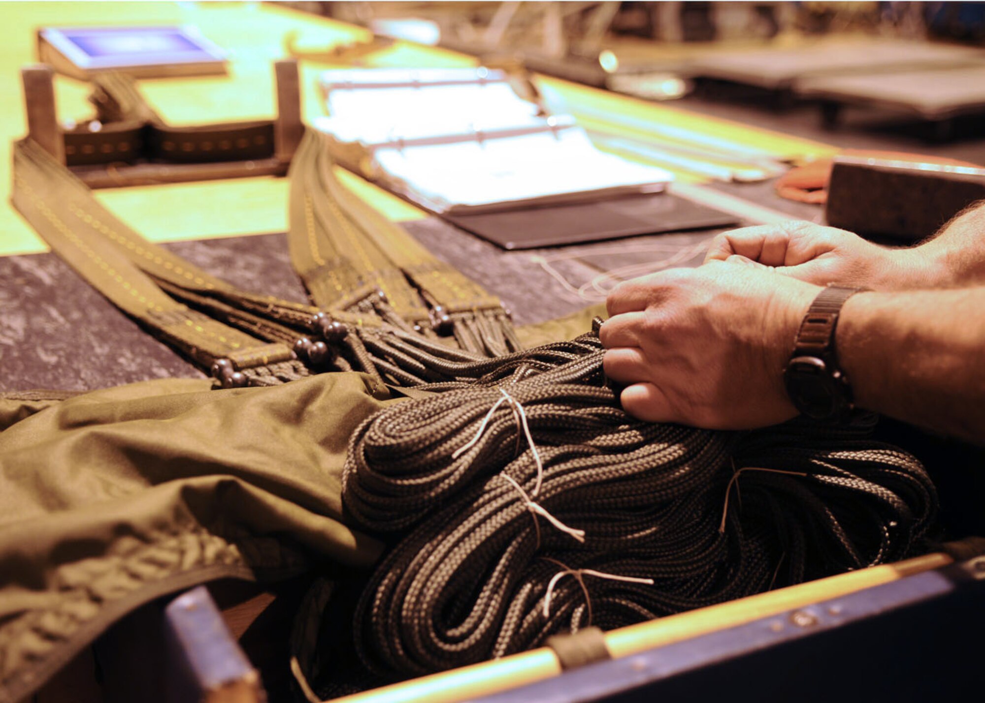 RAF MILDENHALL, England -- Master Sgt. Don Serre, an air transportation specialist from the 352nd Operations Support Squadron, ties off lines while packing a 15-foot parachute Oct. 15, 2008. Sgt. Serre carefully ties off sections of line to keep them from becoming entangled during parachute deployment. He and his team pack more than 15 parachutes weekly, ranging from 15 to 64 feet in diameter. (U.S. Air Force photo by Staff Sgt. Jerry Fleshman)