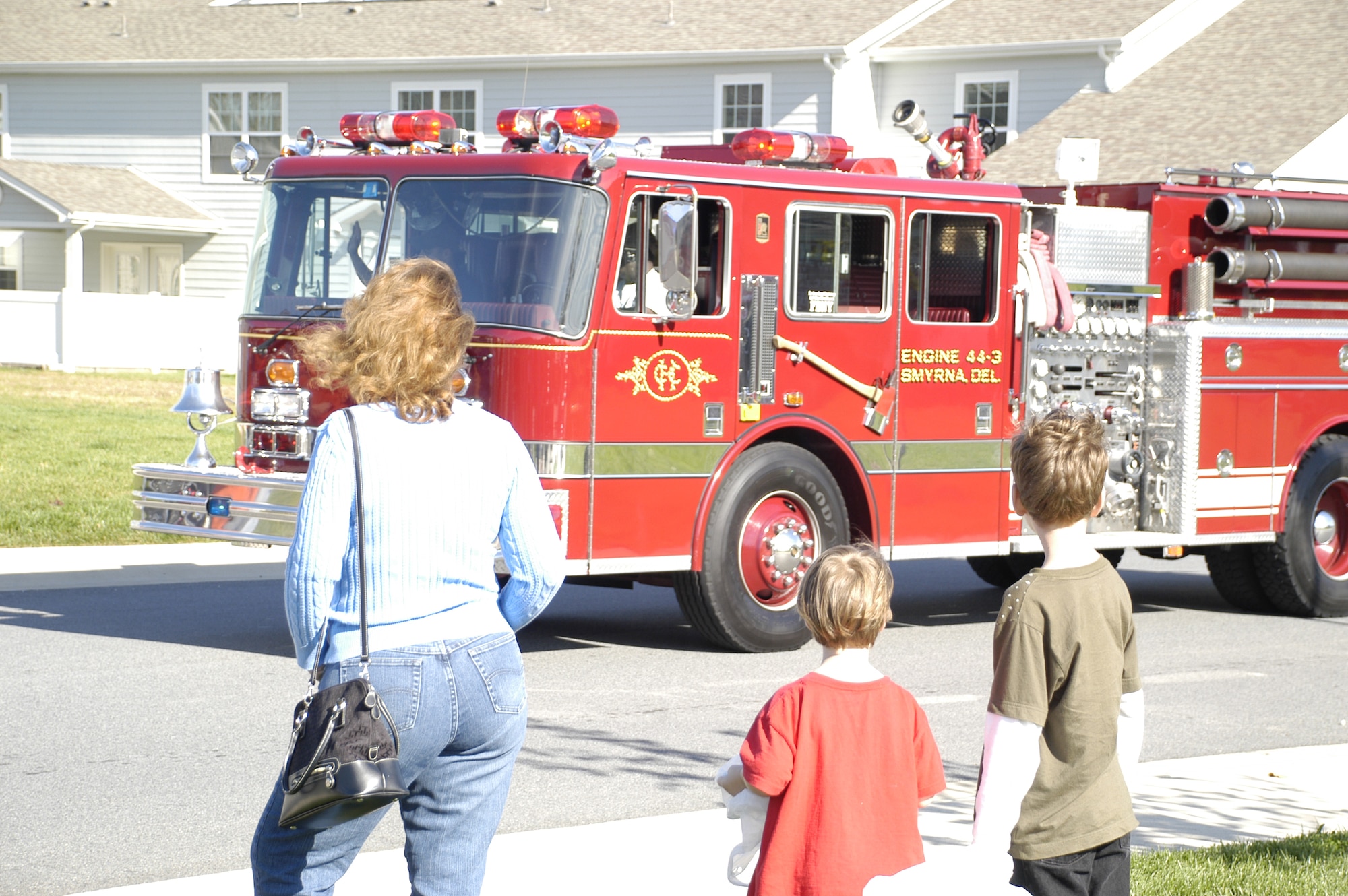 Base housing residents watch equipment from Dover Air force Base Fire Station and six off base agencies parade through Eagle Heights Oct. 11.  The parade was part of Fire Prevention Week.  (U.S. Air Force photo by Staff Sgt. Chad Padgett)                            