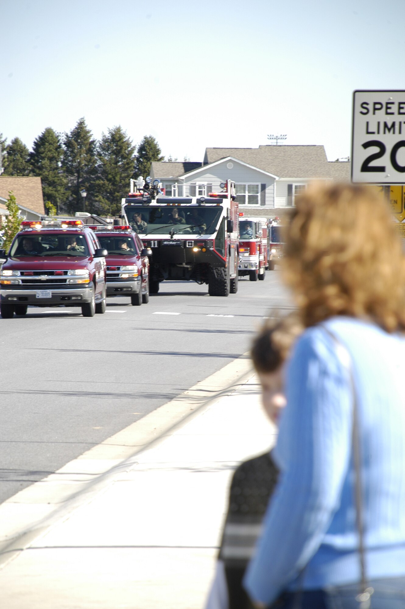 Base housing residents watch equipment from Dover Air force Base Fire Station and six off base agencies parade through Eagle Heights Oct. 11.  The parade was part of Fire Prevention Week.  (U.S. Air Force photo by Staff Sgt. Chad Padgett)                                 