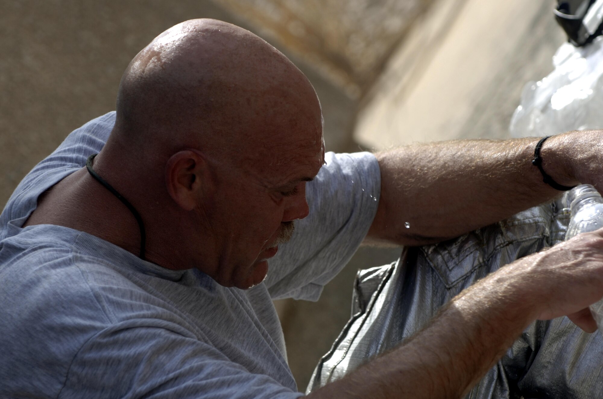 10/15/2008 ? SATHER AIR BASE, Iraq ? Master Sgt. Jeffrey Cable takes a moment to cool down during a live burn exercise at Sather Air Base. Sergeant Cable is a Tennessee Air National Guard firefighter deployed from the 134th Air Refueling Wing, McGhee Tyson Air National Guard Base, and is the assistant fire chief assigned to the 447th Expeditionary Civil Engineer Squadron. When he is not deployed in support of combat operations, he serves as an administrative lieutenant for the Department of Children?s Services.  Sergeant Cable?s unit is responsible for fire protection and rescue operations for the base and airfield on the west side of Baghdad International Airport, one of the busiest aerial hubs in Iraq. (U.S. Air Force photo by Master Sgt. Brian Davidson)
