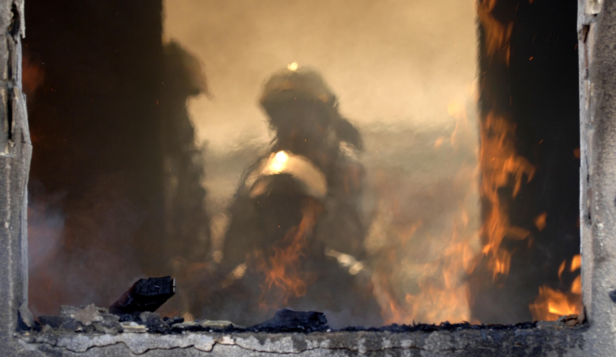 10/15/2008 ? SATHER AIR BASE, Iraq - Firefighters from the 447th Expeditionary Civil Engineer Squadron at Sather Air Base move in to extinguish a structure fire during a live burn exercise. The unit is made up of Air National Guard Airmen who are responsible for fire protection and rescue operations for the base and airfield on the west side of Baghdad International Airport, one of the busiest aerial hubs in Iraq. (U.S. Air Force photo by Master Sgt. Brian Davidson)
