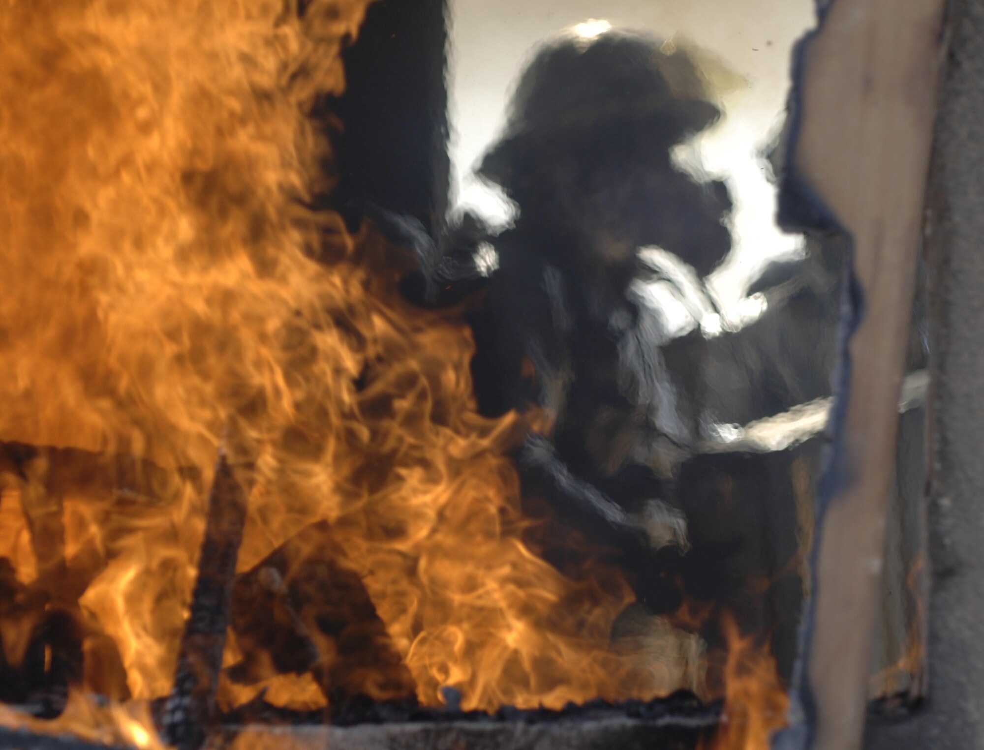 10/15/2008 ? SATHER AIR BASE, Iraq - Firefighters from the 447th Expeditionary Civil Engineer Squadron at Sather Air Base move in to extinguish a structure fire during a live burn exercise. The unit is made up of Air National Guard Airmen who are responsible for fire protection and rescue operations for the base and airfield on the west side of Baghdad International Airport, one of the busiest aerial hubs in Iraq. (U.S. Air Force photo by Master Sgt. Brian Davidson)