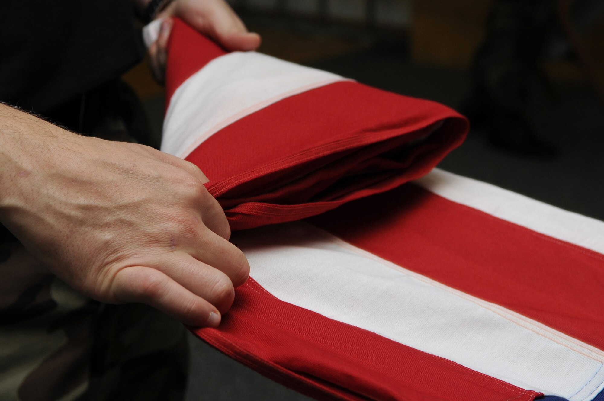 Air Force members practice flag folding during one of their Honor Guard practice, Ramstein Air Base, Germany, Oct. 15, 2008.The Ramstein Honor Guard practice weekly to ensure they all look sharp during any type of ceremony. (U.S. Air Force photo by Airman 1st Class Grovert Fuentes-Contreras)