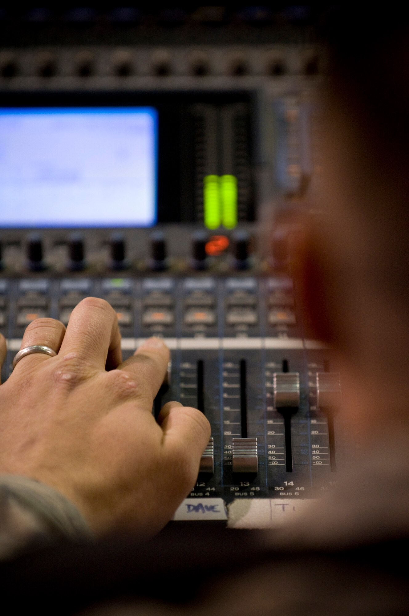 BAGRAM AIR FIELD, Afghanistan -- Tech. Sgt. Adam Dempsey, audio engineer for U.S. Air Forces Central band "Yuma," adjusts sound levels during the band's feature performance here Oct. 10. Although normally "behind the stage," Sergeant Dempsey's role is vital to a successful show for Yuma. (U.S. Air Force photo by Staff Sgt. Samuel Morse)