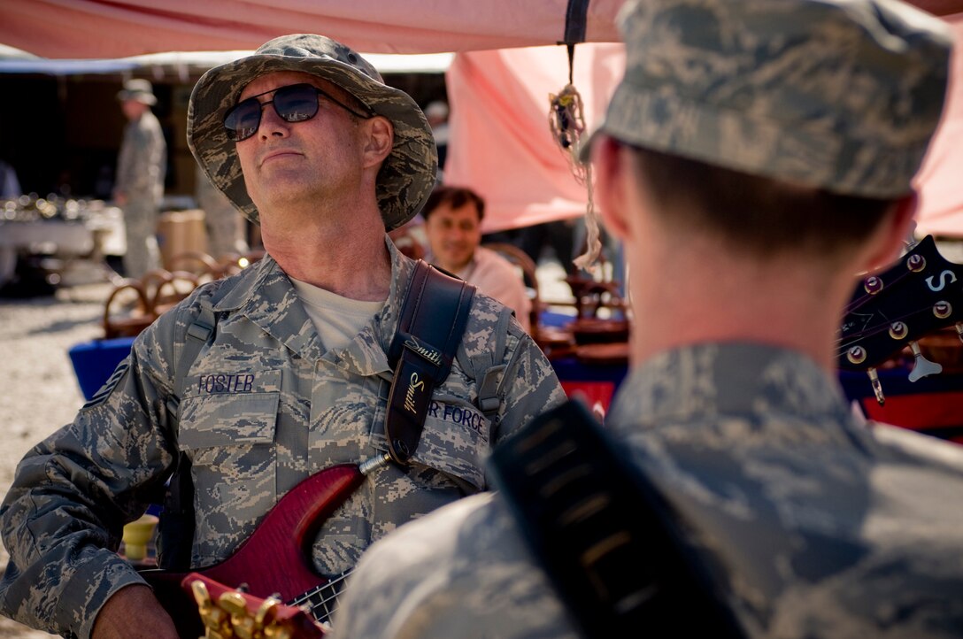 BAGRAM AIR FIELD, Afghanistan -- Tech. Sgt. David Foster, bassist for U.S. Air Forces Central band "Yuma," plays with the rest of the rhythm section at the weekly bazaar here Oct. 10. The performance promoted their feature show that afternoon. (U.S. Air Force photo by Staff Sgt. Samuel Morse)