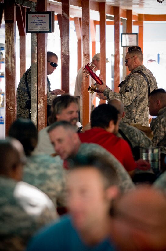 BAGRAM AIR FIELD, Afghanistan -- The rhythm section of U.S. Air Forces Central band "Yuma" plays music in the Army Air Force Exchange food court here Oct. 9. The performance promoted their feature show the following day. (U.S. Air Force photo by Staff Sgt. Samuel Morse)