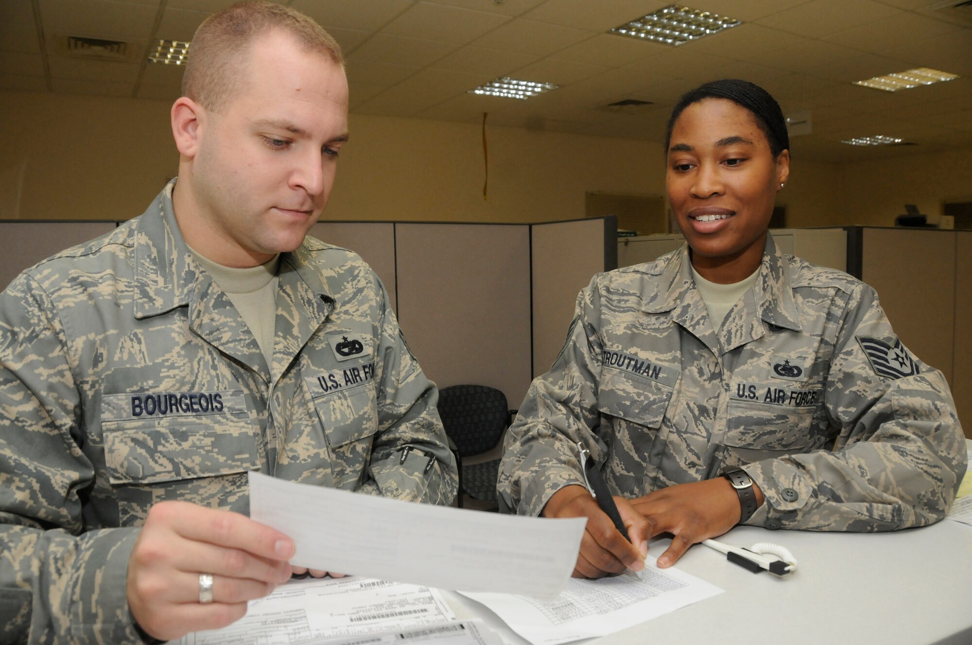 Staff Sgt. Edward Bourgeois, Non commissioned officer in charge of passenger travel, and Tech. Sgt. Tomarra Troutman, Non commissioned officer in charge of night shift, reconcile tracking numbers from a log to tracking numbers on issue release/receipt documents Oct. 15, 2008, at an undisclosed air base in Southwest Asia. Both sergeants are assigned to the Expeditionary Logistics Readiness Squadron, where they are responsible for receiving and shipping supply parts for all assigned aircraft. Sergeant Bourgeois, a native of Phoenix, Ariz., is deployed from Royal Air Force Mildenhall, United Kingdom, and Sergeant Troutman, a native of Detroit, Mich., is deployed from Robins Air Force Base, Ga.  Both are deployed in support of Operations Iraqi and Enduring Freedom and Joint Task Force-Horn of Africa. (U.S. Air Force photo by Staff Sgt. Darnell T. Cannady/Released)