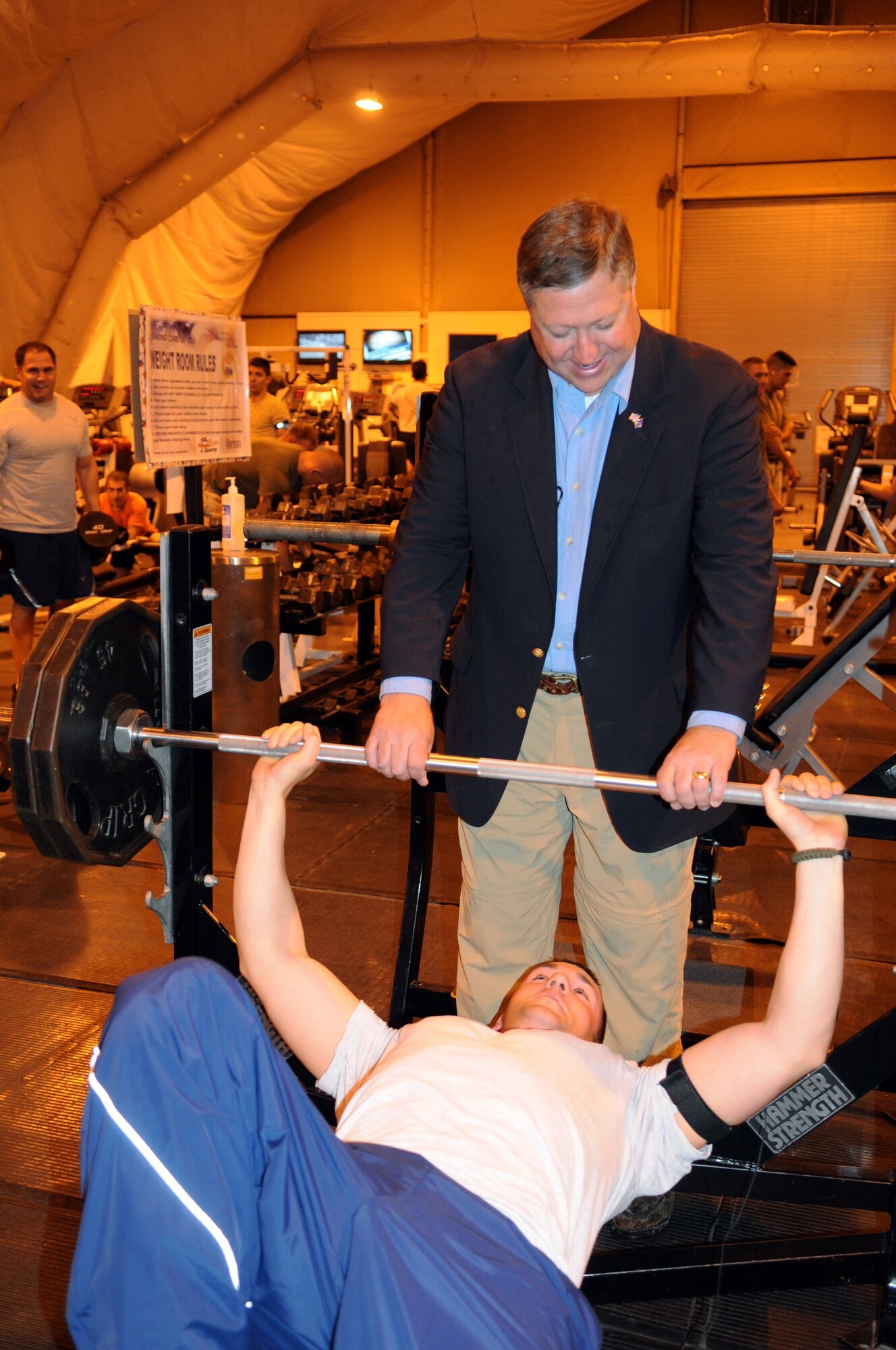 MANAS AIR BASE, KYRGYZSTAN -- Secretary of the Air Force Michael Donley provides a 'spot' for Senior Airman Joshua Benedict, 376th Expeditionary Security Forces Squadron, during a stop at the fitness center during the secretary's visit here, Oct. 15. Manas AB was the final stop in Secretary Donley's first trip to the U.S. Air Forces Central Command area of operations. (Air Force photo / Senior Airman Ruth Holcomb)