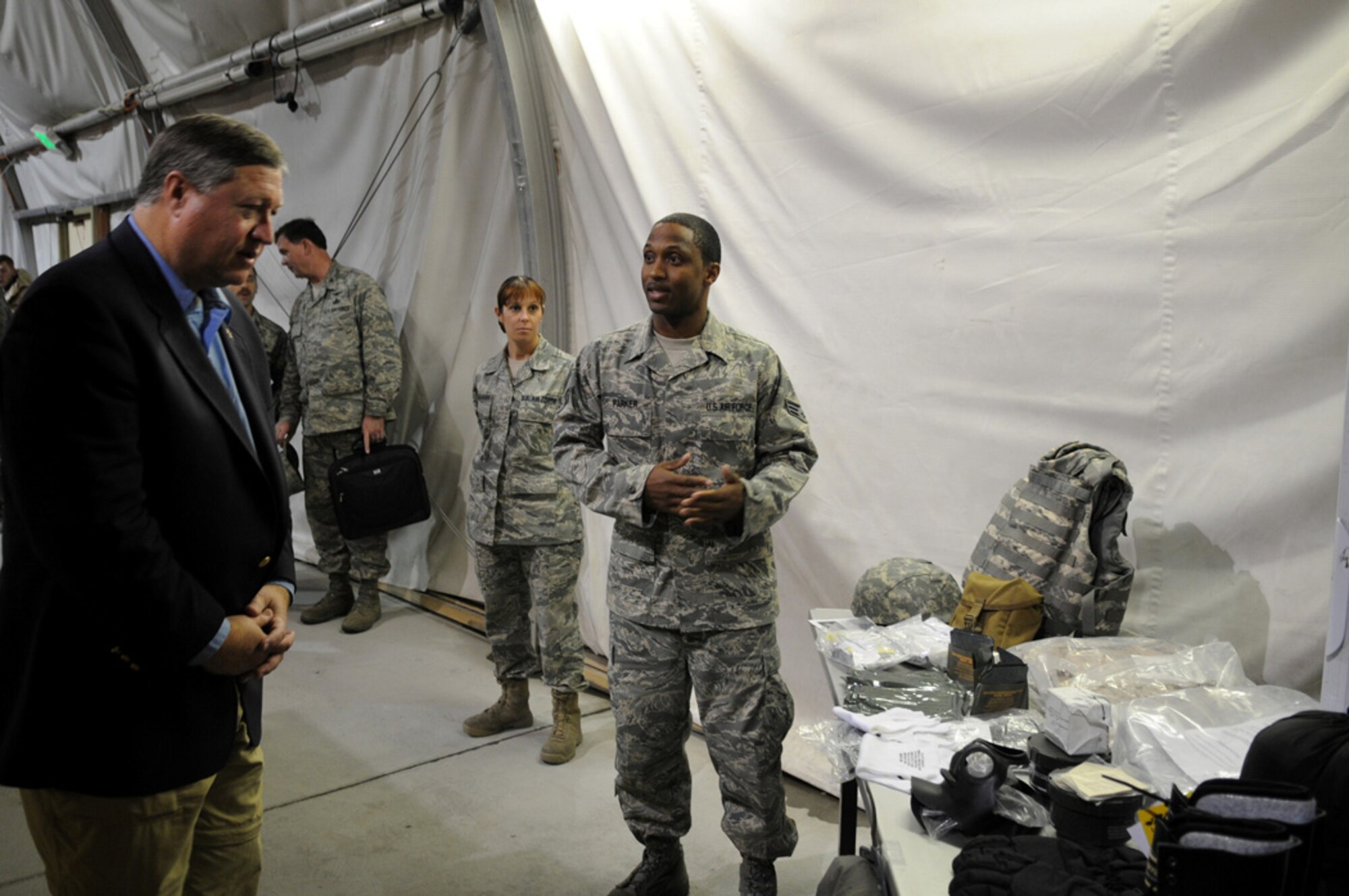 10/15/2008 - MANAS AIR BASE, KYRGYZSTAN -- Senior Airman Sean Parker, 376th Expeditionary Theater Distribution Center, briefs Secretary of the Air Force Michael Donley about the ETDC mission during his brief tour here, Oct.15. Manas AB was the final stop in the secretary's first trip to the U.S. Air Forces Central area of responsibility. While at Manas, he toured the base and held an Airman's call for more than 200 Airmen to share with them the latest on Air Force issues and priorities. (Air Force photo / Senior Airman Ruth Holcomb) 