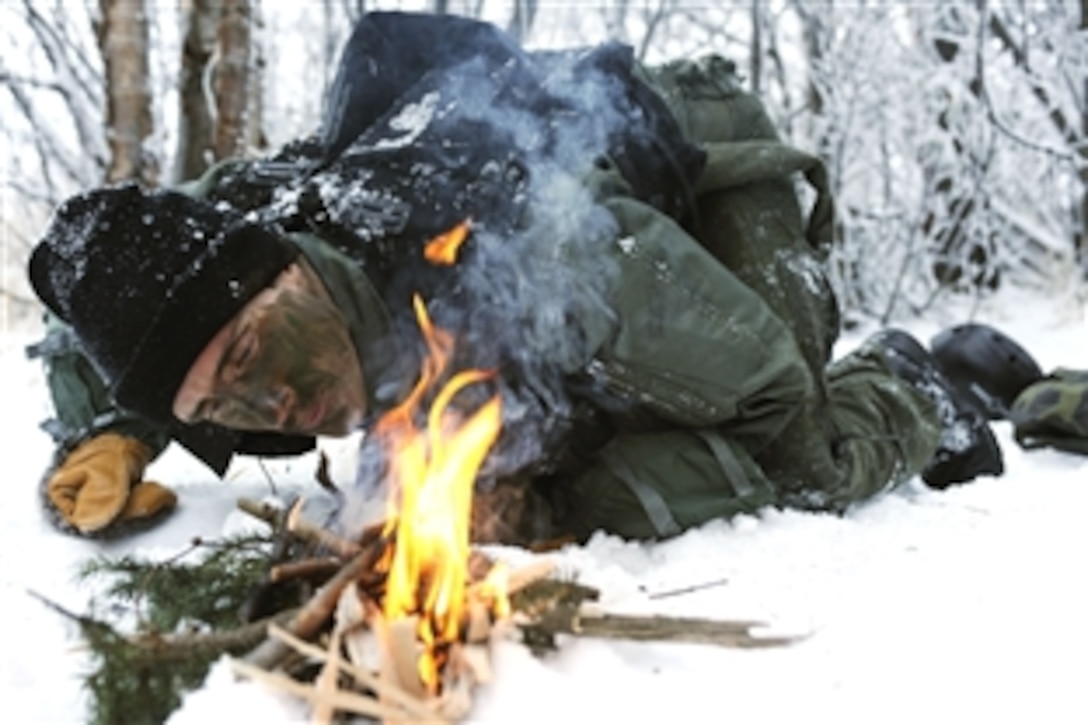 U.S. Air Force 1st Lt. Matthew Feeman  builds a fire to help combat the cold preventing frostbite and hypothermia during RED FLAG-Alaska 09-1 on Eielson Air Force Base, Alaska, Oct. 14, 2008. Feeman is enacting the role of a pilot shot down behind enemy lines. To complete the training he must must survive, evade, resist and escape to successfully complete the training mission. Feeman is assigned to the 80th Fighter Squadron, Kunsan Air Base, Korea.