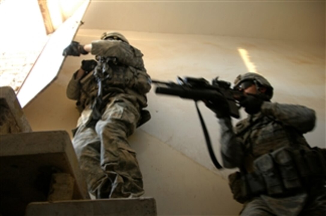 U.S. Army soldiers from 2nd Platoon Bravo Company, 2nd Battalion, 30th Infantry Regiment, 4th Brigade Combat Team, 10th Mountain Division prepare to move onto the roof as they clear a home on Sept. 29, 2008.  Their unit is conducting Operation Boar Wild II, a cordon and search mission in Sharwa Um Jidir, eastern Baghdad, Iraq.  