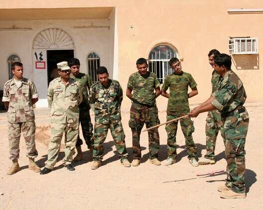 Malek Altameemy (front, right), 22, a native of al-Kut and member of the Desert Wolves, an Iraqi border enforcement battalion, conducts a sign cutting and tracking class Oct. 16 to teach his fellow troops at Border Fort 15 how to identify human footprints in the sand in order to catch insurgents attempting to enter the country illegally.  Altameemy received instruction in how to teach the class from a Marine Corps Border Transition Team at his battalion headquarters Oct. 14 near the Port of Trebil in western al-Anbar province.