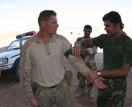 An Iraqi border patrolman practices applying a tourniquet to Maj. Eric Wolf, the commander of Marine Corps Border Transition Team at Trebil, Iraq, during a training exercise at Border Fort 16 near the Iraqi-Jordanian border Oct. 16.  Wolf, who arrived here in August, is responsible for leading his team in training and providing operational overwatch for the Desert Wolves, an Iraqi border enforcement team which patrols the Jordanian border along a 235 km. front.  ::r::::n::