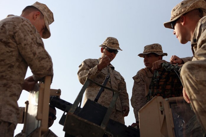 Lance Cpl. Roy Farias Jr., 24, .50 cal machine gunner, Civil Affairs Team 6, Detachment 1, 2nd Battalion, 11th Marine Regiment, Regimental Combat Team 5, instructs Marines on head space and timing on the .50 cal machine gun in Haqlaniyah, Iraq, Oct. 16. Marines and sailors with CA Team 6 give weekly classes on their primary military occupational specialties to better prepare themselves for their duties following redeployment. The classes also give everyone insight on the different MOSs in the Marine Corps. ::r::::n::