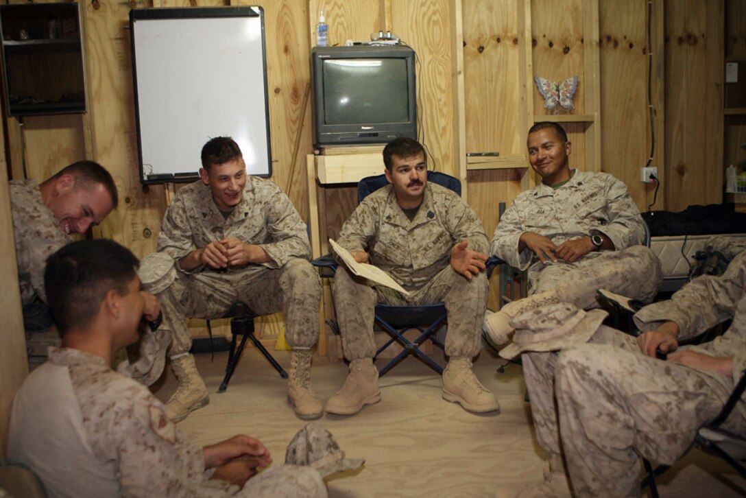 Petty Officer 3rd Class Sean M. Jones, a corpsman with Civil Affairs Team 6, Detachment 1, 2nd Battalion, 11th Marine Regiment, Regimental Combat Team 5, gives an informal class on immunization procedures in Haqlaniyah, Iraq, Oct. 16. Marines and sailors with CA Team 6 were pulled from their respective billets for a yearlong deployment to al-Anbar province. Staff Sgt. Graham H. Webb, team chief with CA Team 6, came up with the idea to implement weekly classes that the Marines and sailors teach to the rest off the team so they can maintain their military occupational specialties proficiency while deployed. ::r::::n::