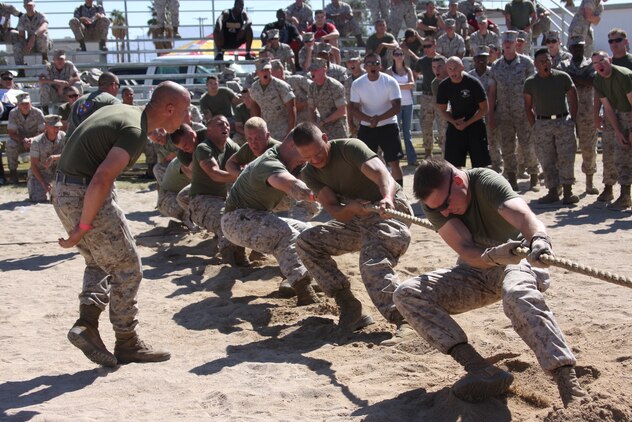 Marines of 1st Battalion, 7th Marine Regiment, dig their heels in the sand as they compete with Marines of Combat Logistics Battalion 7 in the tug-of-war event of the sixth annual Combat Center Challenge at Victory Field Oct. 17.
