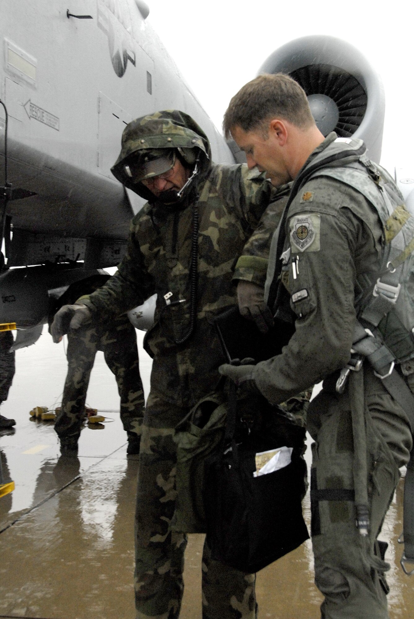 Master Sgt. John Ezell, 442nd Aircraft Maintenance Squadron, left, assists Maj. Preston McConnell, a 303rd Fighter Squadron A-10 Thunderbolt II pilot after Major McConnell's arrival at the Salina, Kan., airport for Hawgsmoke 2008, the Air Force's  biennial A-10 bombing and gunnery competition. Both Airmen are Air Force reservists bsed at Whiteman Air Force Base, Mo. (US Air Force photo/Master Sgt. Bill Huntington)