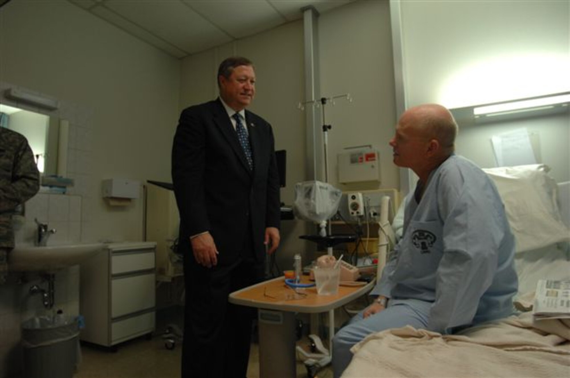 Secretary of the Air Force Michael B. Donley (left) meets with Randall Sumerall during his tour of the Landstuhl Regional Medical Center in Germany, Oct. 10.  Mr. Sumerall is a contractor who was wounded while serving at Joint Base Balad, Iraq. (U.S. Air Force photo/Senior Airman Amber Bressler)