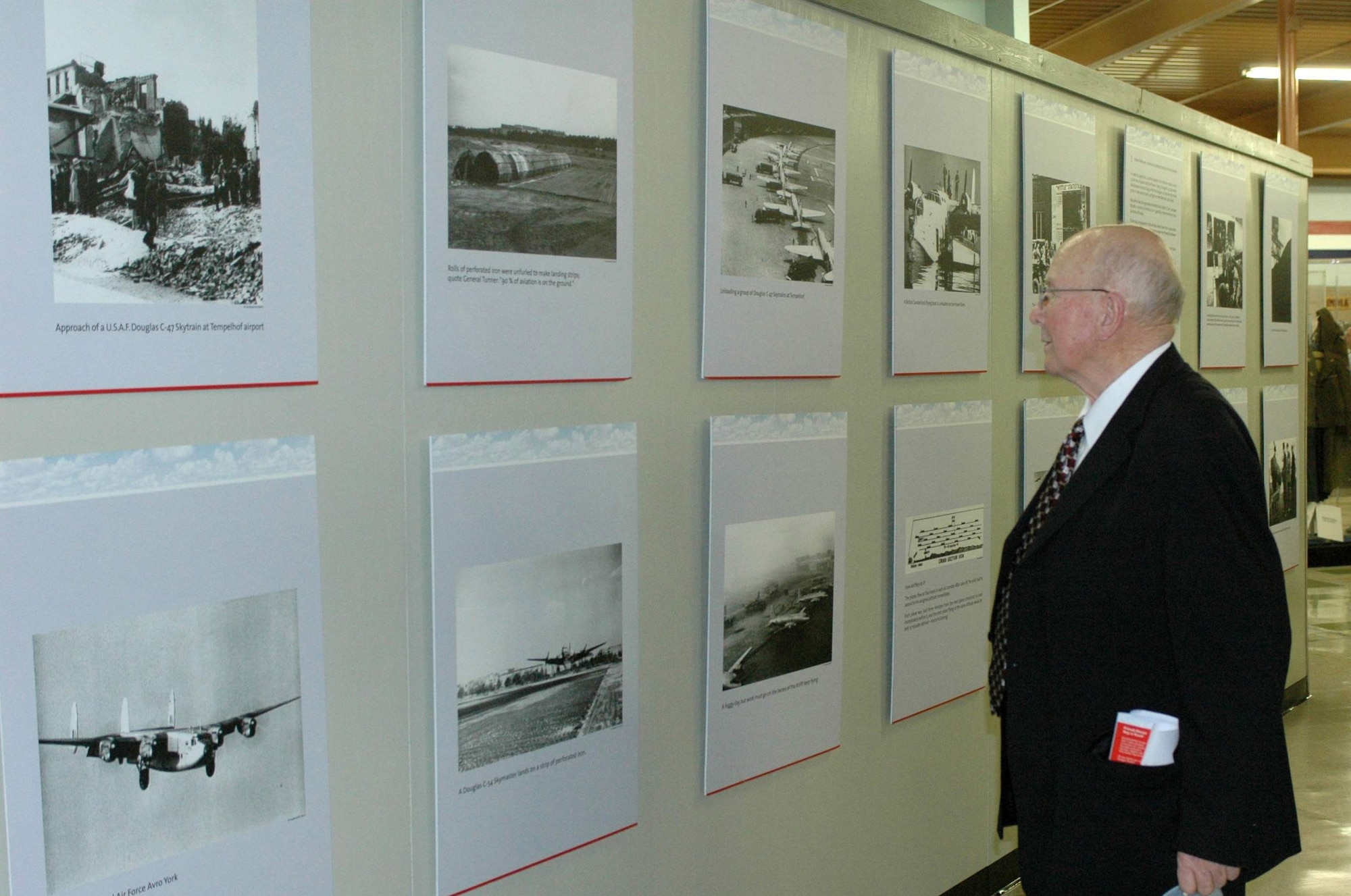Retired Lt. Col. Clinton Hankins walks through the 60th anniversary exhibit on display Oct. 15 at Travis Air Force Base, Calif. Colonel Hankins along with 23 fellow Berlin Airlift veterans were presented the German-American Friendship Award for their contributions to German-American relations. He is a a Berlin Airlift veteran. (U.S. Air Force photo/Airman 1st Class Kristen Rohrer) 
