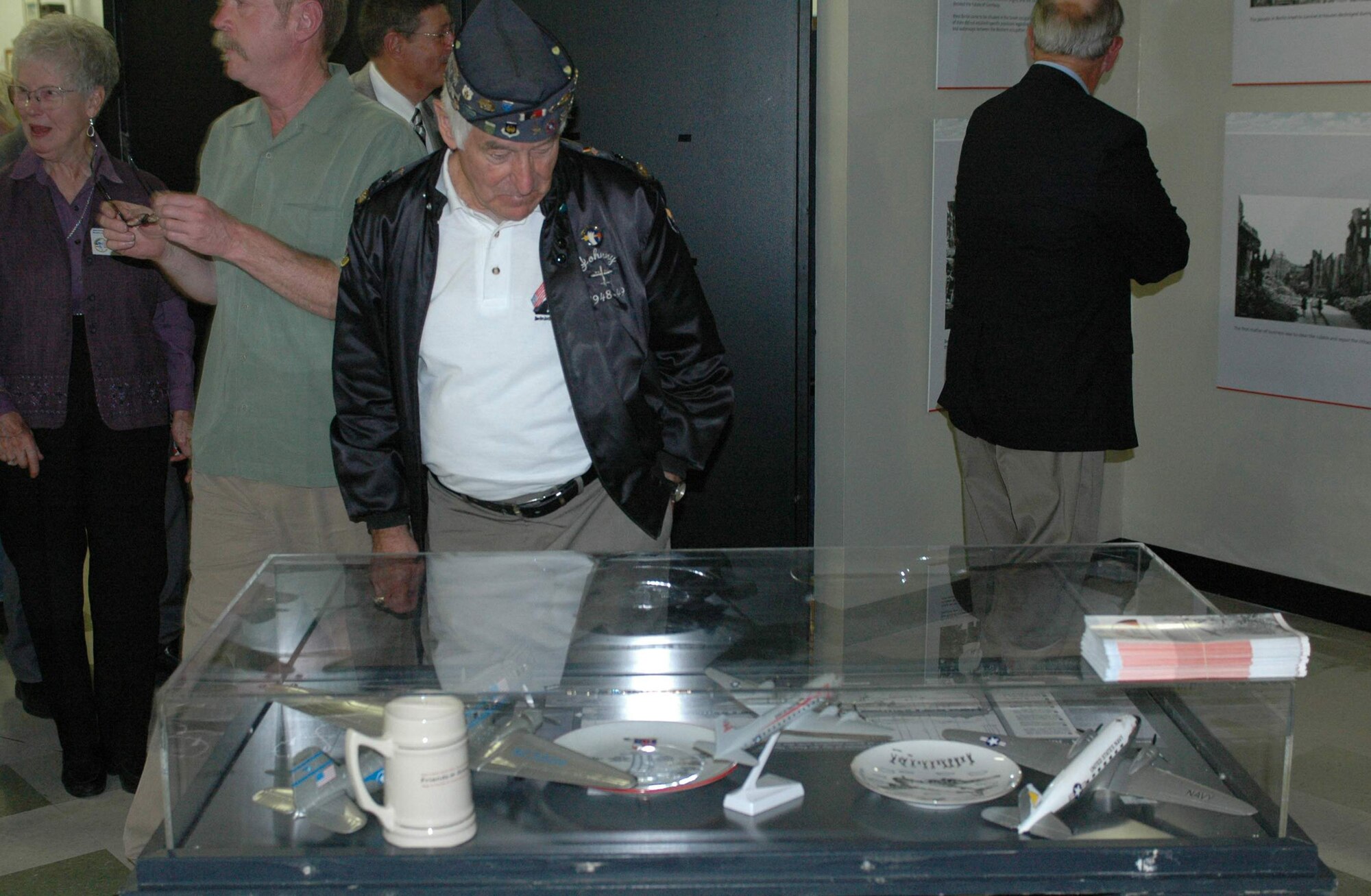 Retired Master Sgt. Johnny Macia looks at artifacts from the Berlin Airlift as he walks through the 60th anniversary of the Berlin Airlift exhibit Oct. 15 at Travis Air Force Base, Calif. He is a a Berlin Airlift veteran. (U.S. Air Force photo/Airman 1st Class Kristen Rohrer) 
