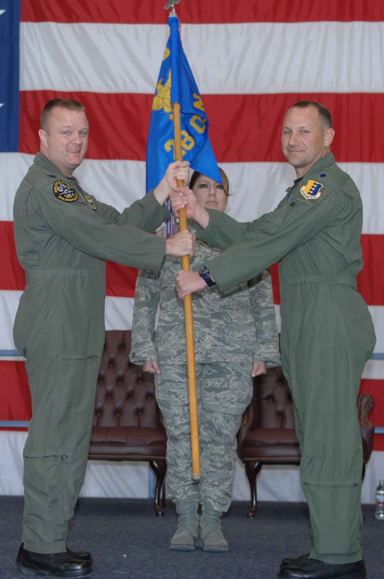 (Right to left) Lt. Col. Gentry Boswell, incoming 28th Operations Support Squadron commander, receives the guidon from Col. Buck Shawhan, 28th Operations Group commander, during a change of command ceremony Oct. 17. By receiving the guidon, Colonel Boswell assumes command of the 28 OSS. (U.S. Air Force photo/Airman 1st Class Joshua Seybert)