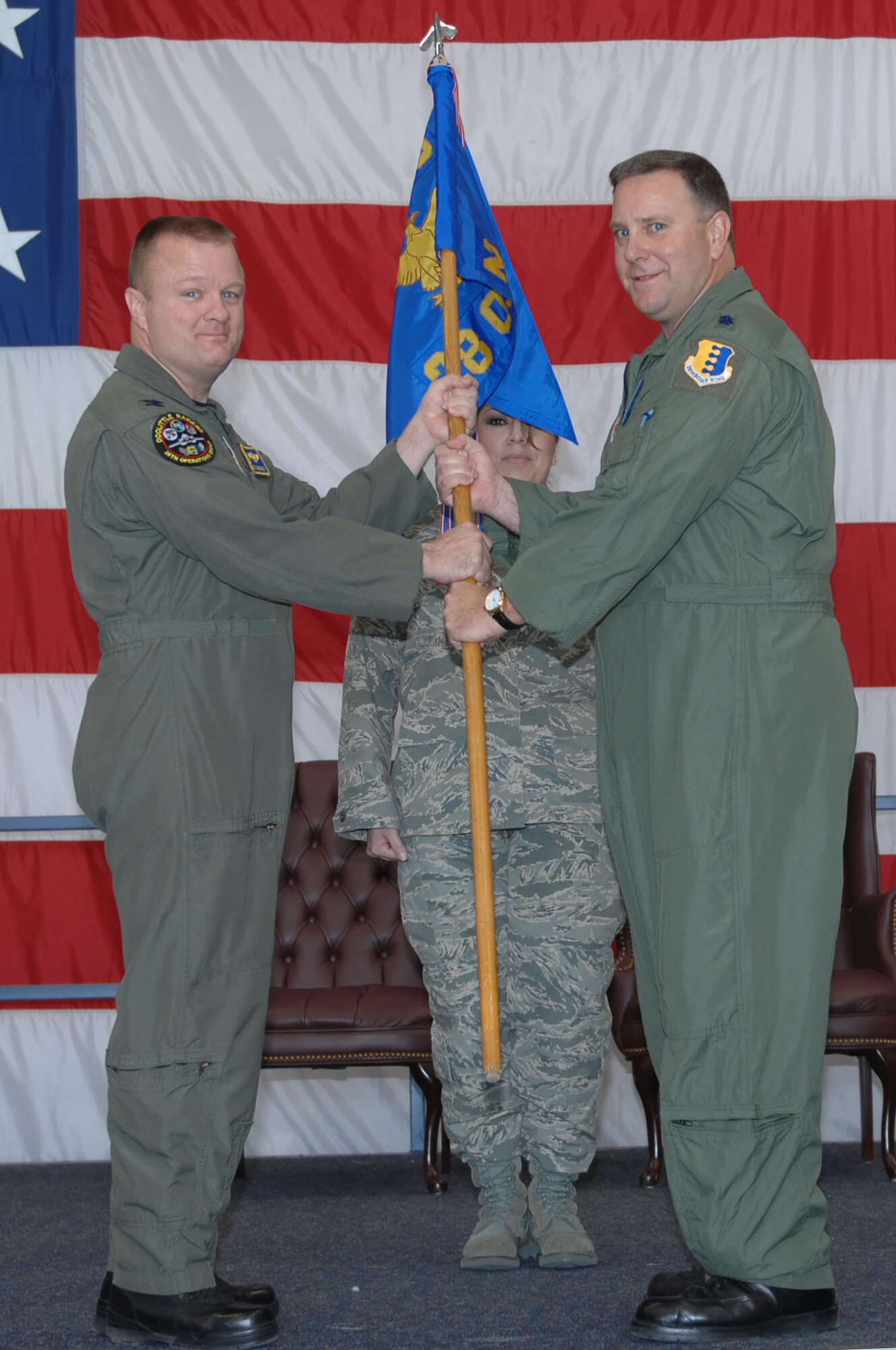 (Right to left) Lt. Col. David Garrett, outgoing 28th Operations Support Squadron commander, hands the guidon to Col. Buck Shawhan, 28th Operations Group commander, during a change of command ceremony Oct. 17. By handing the guidon off, Colonel Garrett relinquishes command of the 28 OSS. (U.S. Air Force photo/Airman 1st Class Joshua Seybert)