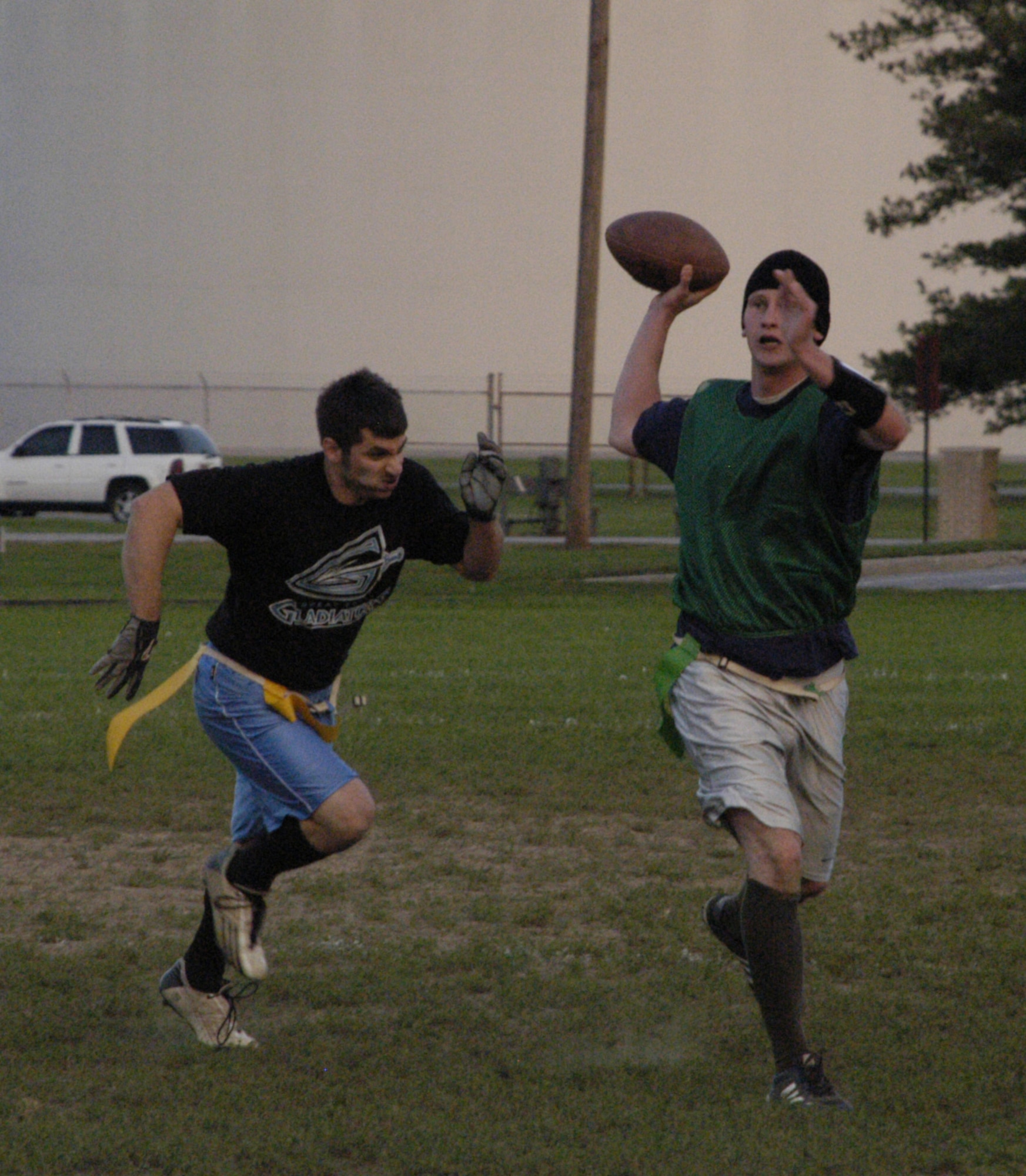 Chris Corbin, CES nose tackle, chases Robert Duray, CS quarterback, during their game Oct. 15.  (U.S. Air Force Photo/Staff Sgt. Chad Padgett)                                     