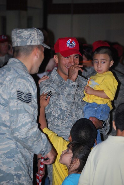 About 110 Airmen from the 556th REDHORSE Squadron returned from deployment on Sunday, October 12, 2008. When the Reserve Airmen arrived home, about 300 friends, family and unit members were there to welcome them with hugs and hand-made banners. REDHORSE is an acronym for Rapid Engineer Deployable Heavy Operational Repair Squadron Engineers. The REDHORSE Airmen deployed to three different countries within the U.S. Central Command Area of Responsibility. During the deployment, they dug wells for Afghanis, repaired existing structures in Iraq and supported base construction and repair needs throughout the AOR. The 556th REDHORSE Squadron is due to relocate to Florida later this year but many of the Reservists will remain at Lackland Air Force Base as new members of the 433rd Civil Engineer Squadron. (U.S. Air Force Photo/Master Sgt. Collen McGee)