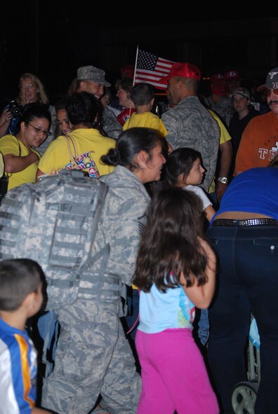 About 110 Airmen from the 556th REDHORSE Squadron returned from deployment on Sunday, October 12, 2008. When the Reserve Airmen arrived home, about 300 friends, family and unit members were there to welcome them with hugs and hand-made banners. REDHORSE is an acronym for Rapid Engineer Deployable Heavy Operational Repair Squadron Engineers. The REDHORSE Airmen deployed to three different countries within the U.S. Central Command Area of Responsibility. During the deployment, they dug wells for Afghanis, repaired existing structures in Iraq and supported base construction and repair needs throughout the AOR. The 556th REDHORSE Squadron is due to relocate to Florida later this year but many of the Reservists will remain at Lackland Air Force Base as new members of the 433rd Civil Engineer Squadron. (U.S. Air Force Photo/Master Sgt. Collen McGee)