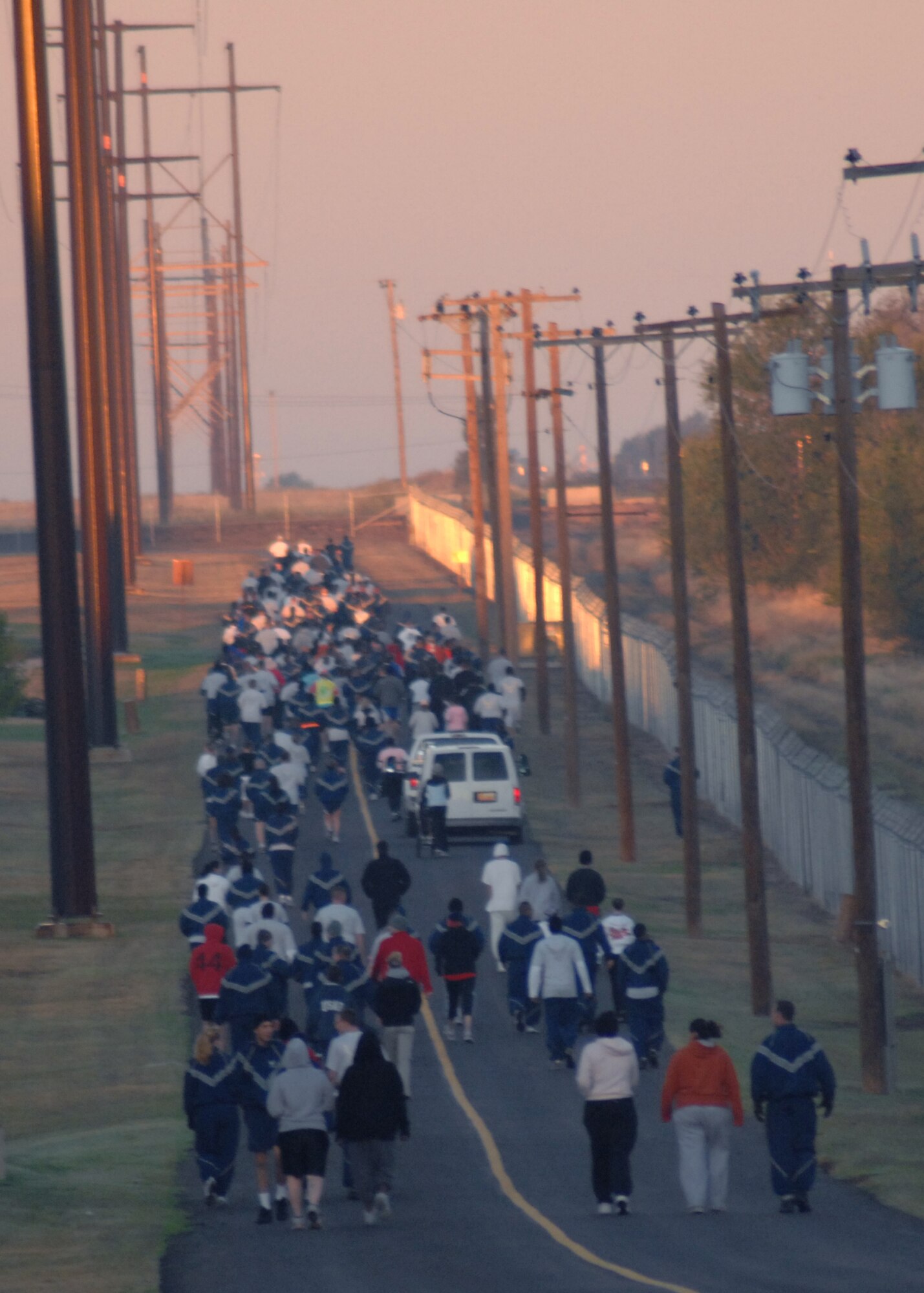 CANNON AIR FORCE BASE, N.M. -- Airmen and their families run down a straight stretch during the Breast Cancer Awareness Month 5K run hosted by the 27th Special Operations Services Squadron Oct. 16. The first  three women and men to cross the finish line received prizes.  (U.S. Air Force photo by Airman 1st Class James R. Bell)