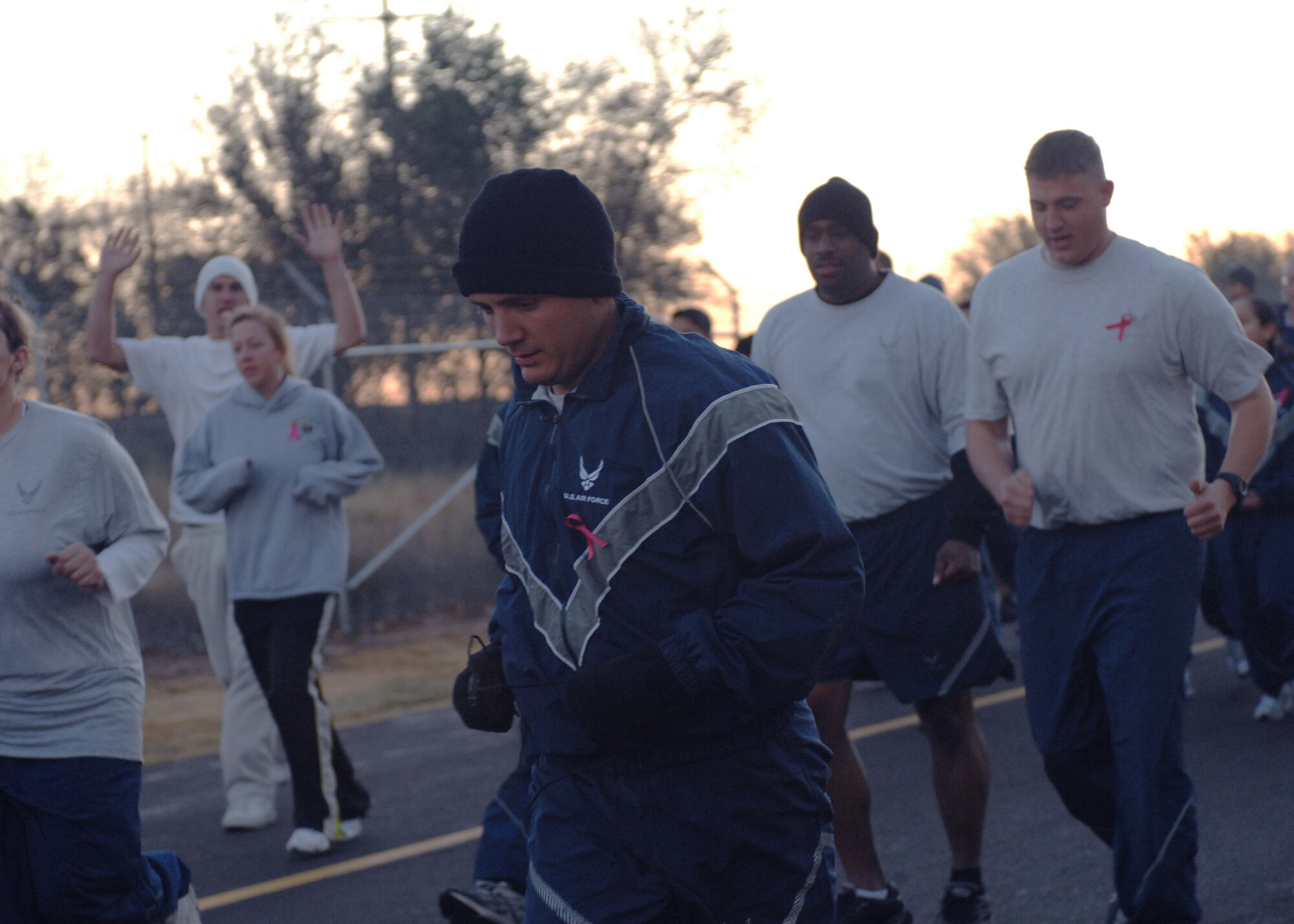 CANNON AIR FORCE BASE, N.M. -- Breast Cancer Awareness Month 5K run participants head down Perimeter Road on Oct. 16.  Participants wore pink ribbons to make others aware of the month. (U.S. Air Force photo by Airman 1st Class James R. Bell)