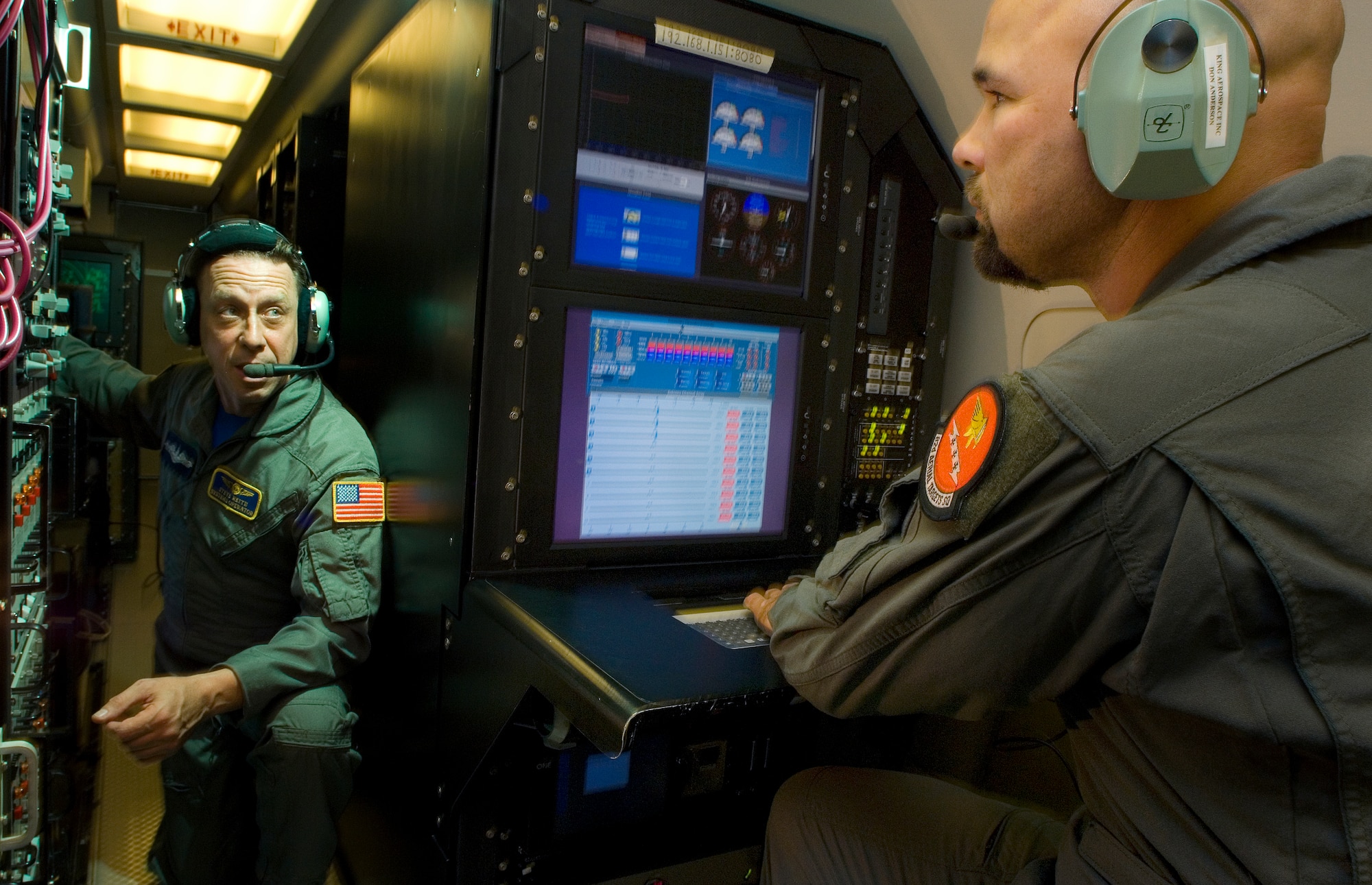 Steven Reith (left) works a UHF relay radio section while Donald Anderson performs instrumentation checks on a sea surveillance radar aboard an E-9A surveillance aircraft Sept. 28 near Tyndall Air Force Base, Fla. Mr. Reith is a sea surveillance radar operator, and Mr. Anderson is an airborne instrumentation and telemetry operator. (U.S. Air Force photo/Staff Sgt. Bennie J. Davis III)