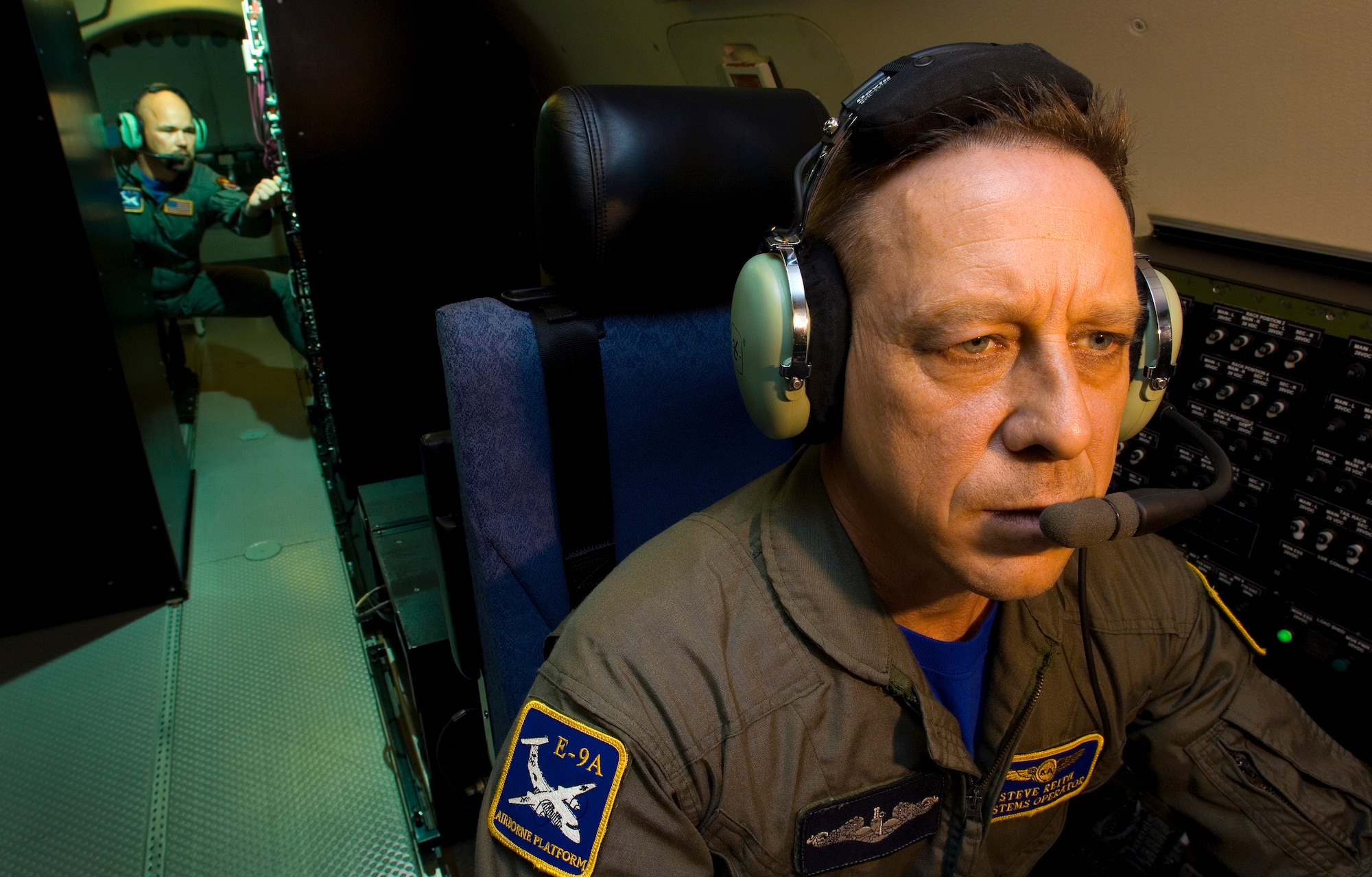 Steven Reith (front) and Donald Anderson preform per-flight instrumentation checks on an E-9A Widget surveillance aircraft Aug. 28 near Tyndall Air Force Base, Fla.  Mr. Reith is a sea surveillance radar operator, and Mr. Anderson is an airborne instrumentation and telemetry operator. (U.S. Air Force photo/Staff Sgt. Bennie J. Davis III)