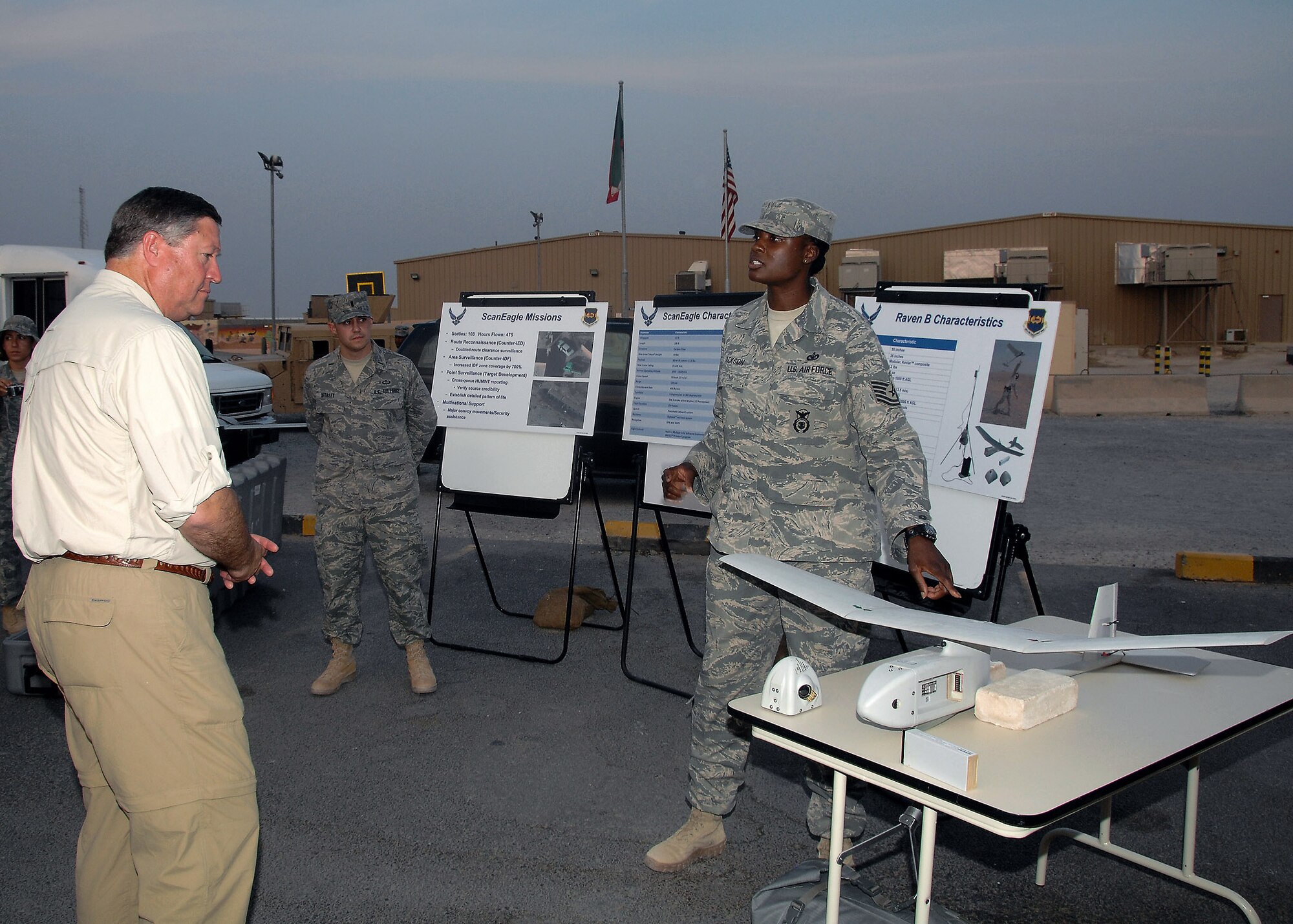 Tech. Sgt. Carmeeka Jackson briefs Secretary of the Air Force Michael B. Donley about the capabilities of a Raven B unmanned aircraft Oct. 14 at an air base in Southwest Asia. Secretary Donley visited with Airmen from the 386th Air Expeditionary Wing, coalition partners and sister services during his visit. Sergeant Jackson is assigned to the 586th Expeditionary Security Forces Squadron. (U.S. Air Force photo/Tech. Sgt. Raheem Moore)