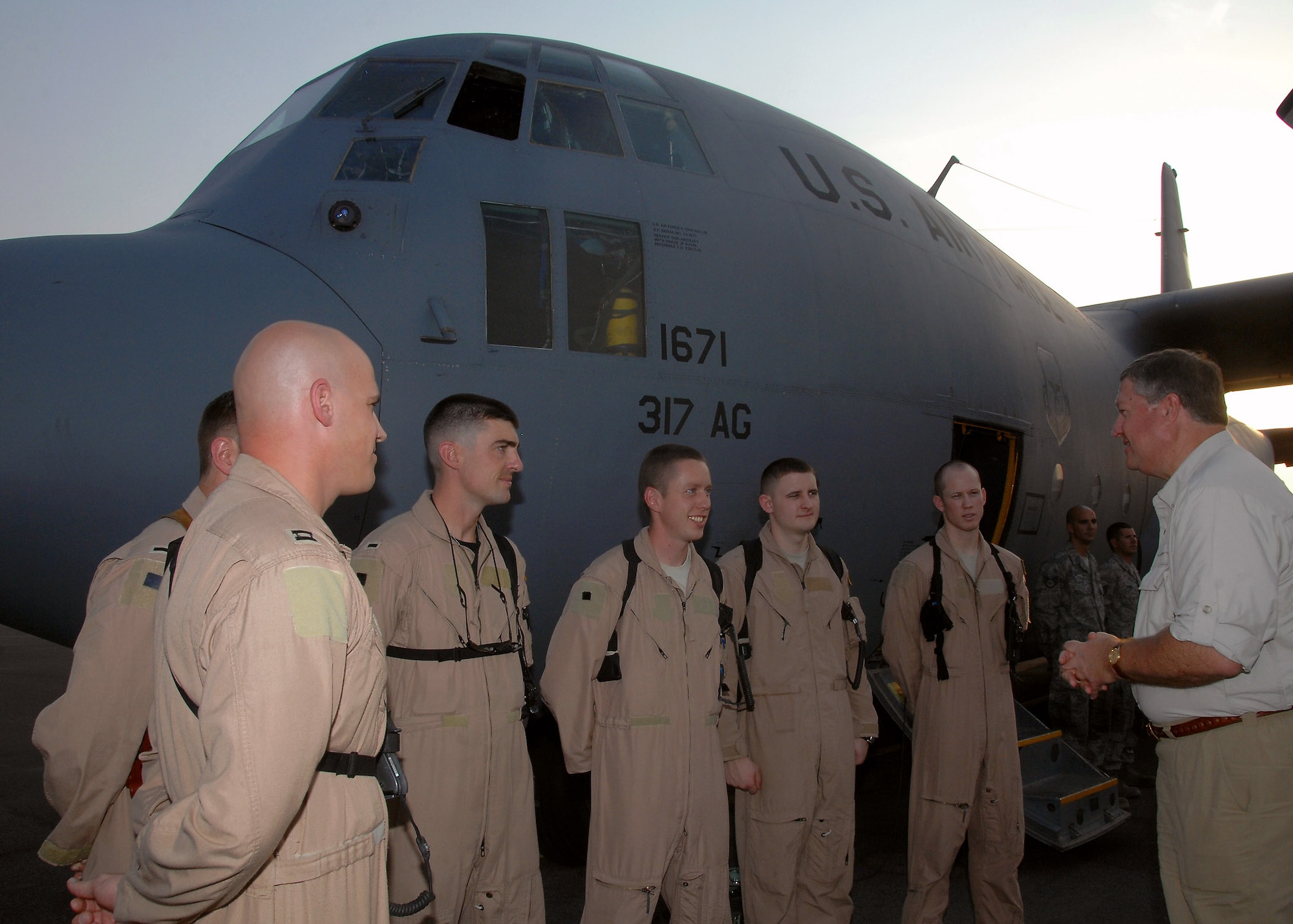 Secretary of the Air Force Michael B. Donley talks with a C-130 Hercules aircrew from the 737th Expeditionary Airlift Squadron Oct. 14 at an air base in Southwest Asia. Secretary Donley visited with Airmen from the 386th Air Expeditionary Wing, coalition partners and sister services during his visit. (U.S. Air Force photo/Tech. Sgt. Raheem Moore)