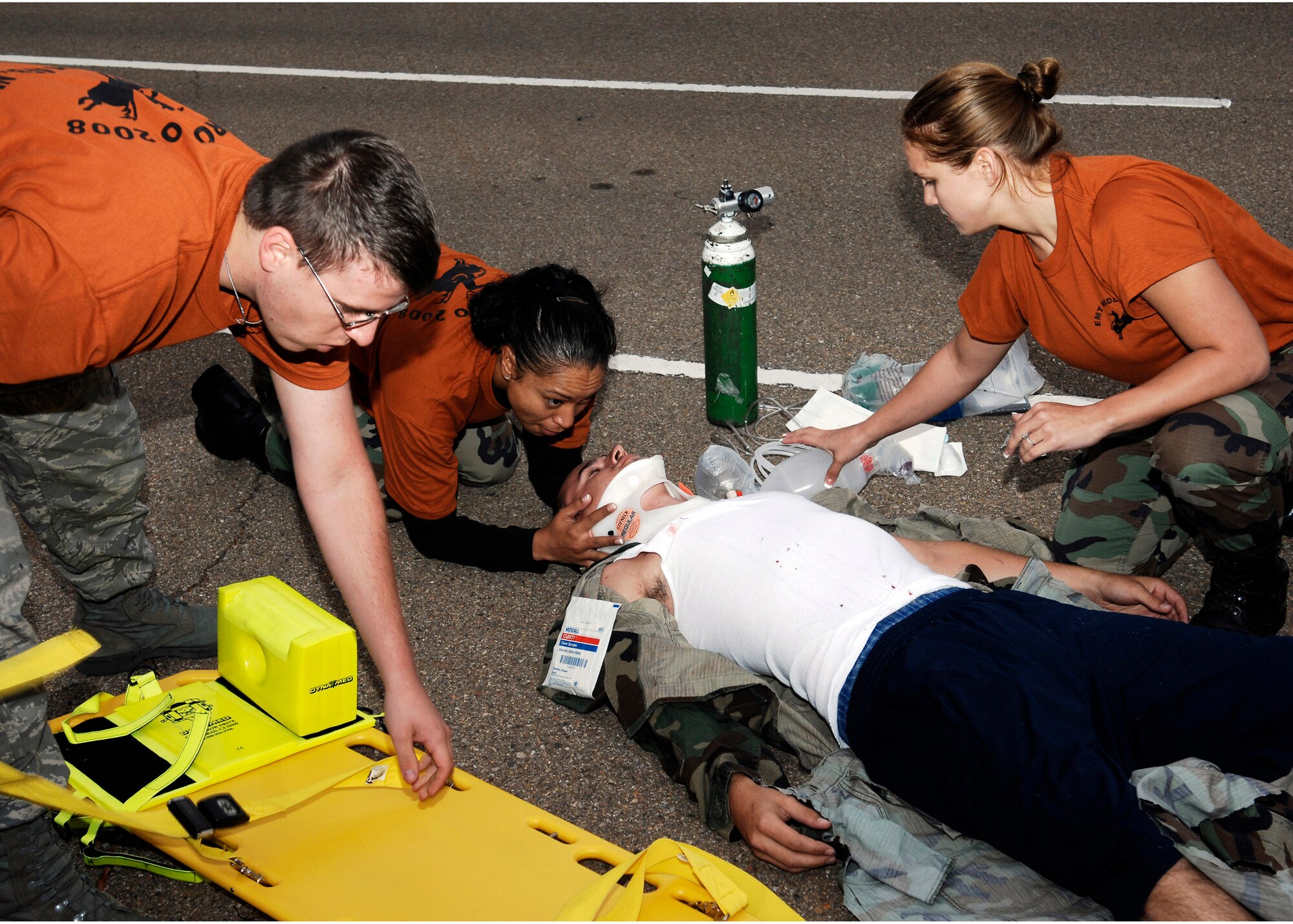 CANNON AIR FORCE BASE, N.M.- (left to right) Airman 1st Class Brian Fox, 27th Special Operations Medical Operations Squadron , Staff Sgt. Joanna Siavii, 27th Special Operations Aerospace Medicine Squadron, and Airman 1st Class Dena Olson, 27th SOMDOS, try to stabilize a "gunshot" victim in a mock trauma assessment during Cannon's Emergency Medical Technician Rodeo Oct. 11. The second annual rodeo was a friendly competition that involved EMTs from across the Air Force.(U.S. Air Force photo/Airman 1st Class Danielle Martin)