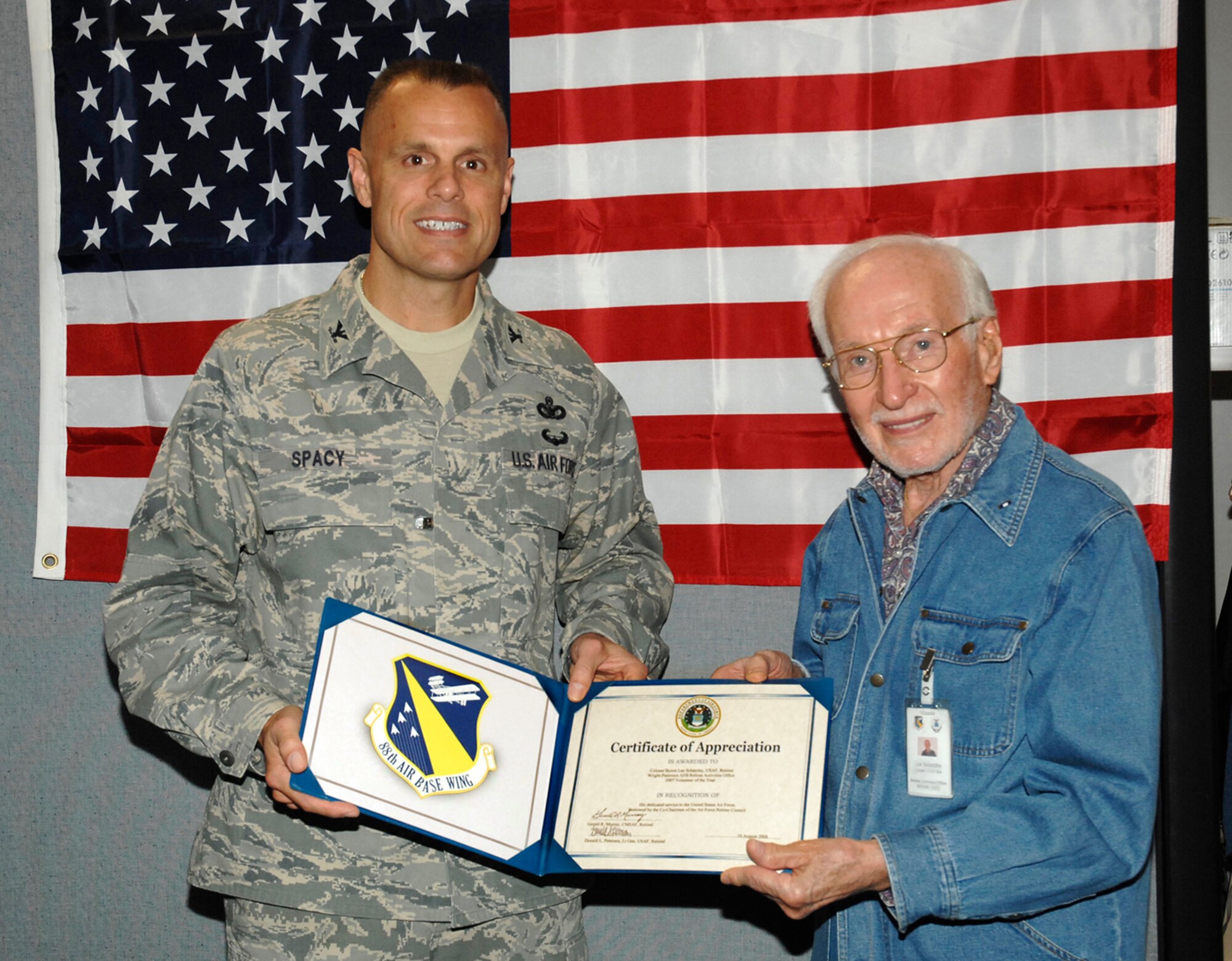 Col. Bradley Spacy, 88th Air Base Wing commander, presents retired Col. Byron Lee Schatzley with the Wright-Patterson Air Force Base Retiree Activities Office Volunteer of the Year Award on Oct. 16.  Col. Schatzley, a Beavercreek Township, Ohio resident, previously directed the base's Retiree Activities Office and continues to volunteer.  The Retiree Activities Office provides information to military retirees, their dependents and survivors, and also coordinates retiree volunteer assistance across the installation. (U.S. Air Force photo/Al Bright)