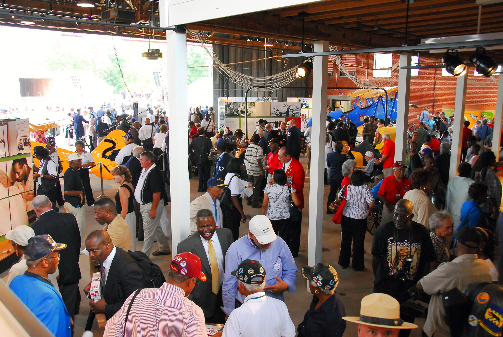 After the opening ceremony of the Tuskegee Airmen National Historic Site Oct. 10 at Moton Field, Ala., visitors explore the interpretive and static displays housed the in the only remaining original hangar of the "Tuskegee Experience." (U.S. Air Force photo/Scott Knuteson)
