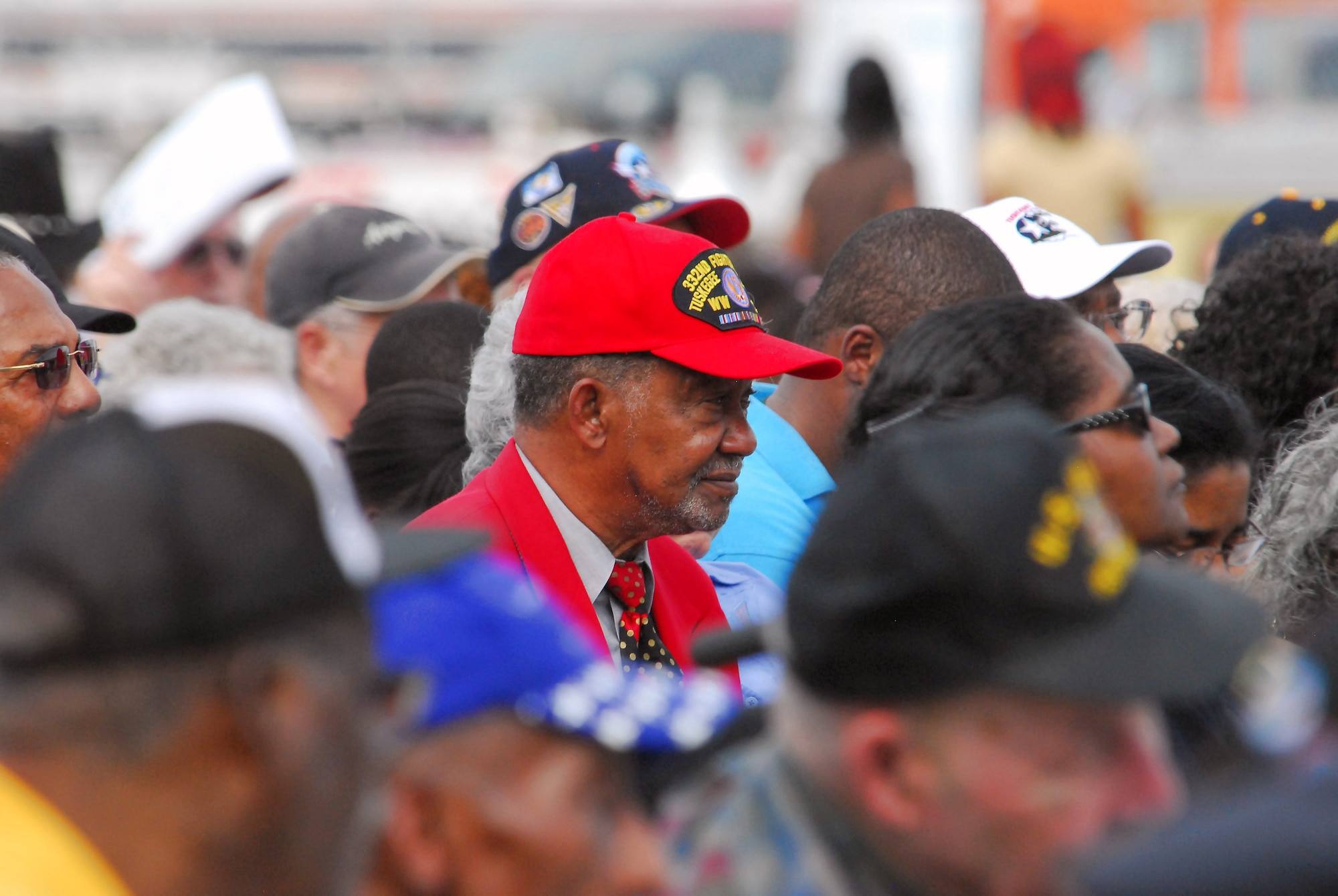One of the documented original Tuskegee Airmen wears the distinctive red hat and jacket at the opening ceremony of the Tuskegee Airmen National Historic Site Oct. 10 at Moton Field, Ala. One estimate notes the Airmen, now in their late 70s and early 80s, are dying at a rate of five per week. (U.S. Air Force photo/Scott Knuteson)
