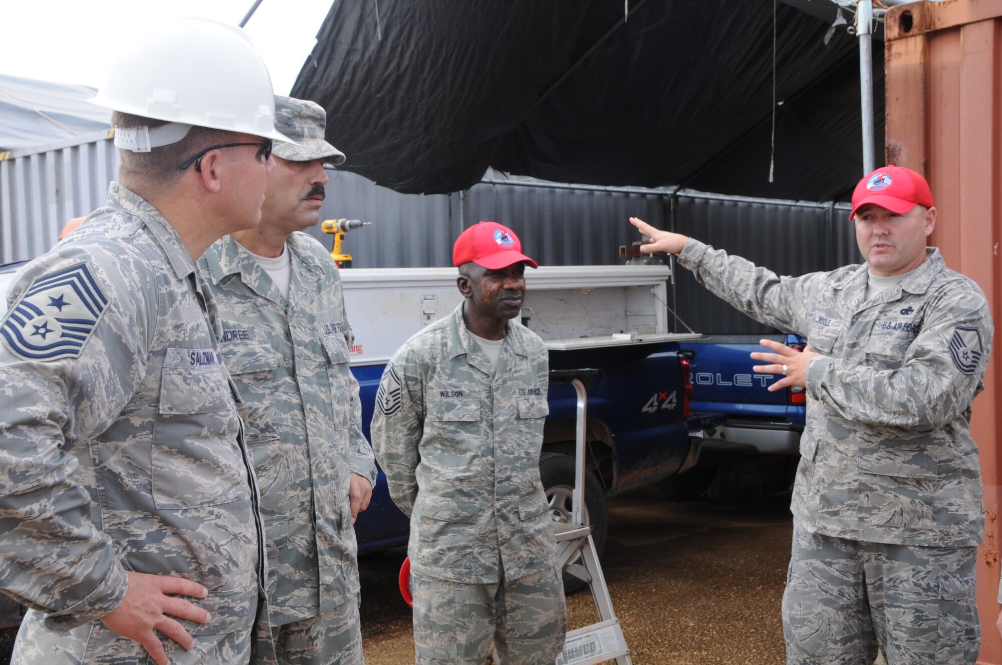 ANDERSEN AIR FORCE BASE, Guam - Airmen from the 554th RED HORSE Squadron describe their working conditions to 13th Air Force Command Chief Master Sgt. Todd Salzman as he visits Northwest Field here Oct. 16. Chief Salzman toured sites on Northwest field such as the new Commando Warrior training facility classroom, the 554th RHS' new facilities and other projects the squadron oversees. (U.S. Air Force photo by Airman 1st Class Courtney Witt)