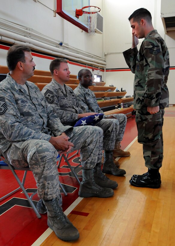 ANDERSEN AIR FORCE BASE, Guam - Andersen Honor Guard member Senior Airman David Lowery presents the flag to the 13th Air Force Command Chief Master Sgt. Todd Salzman during an Honor Guard demonstration here Oct. 16. The pool of Team Andersen guardsmen come from units base-wide. (U.S. Air Force photo by Airman 1st Class Courtney Witt)