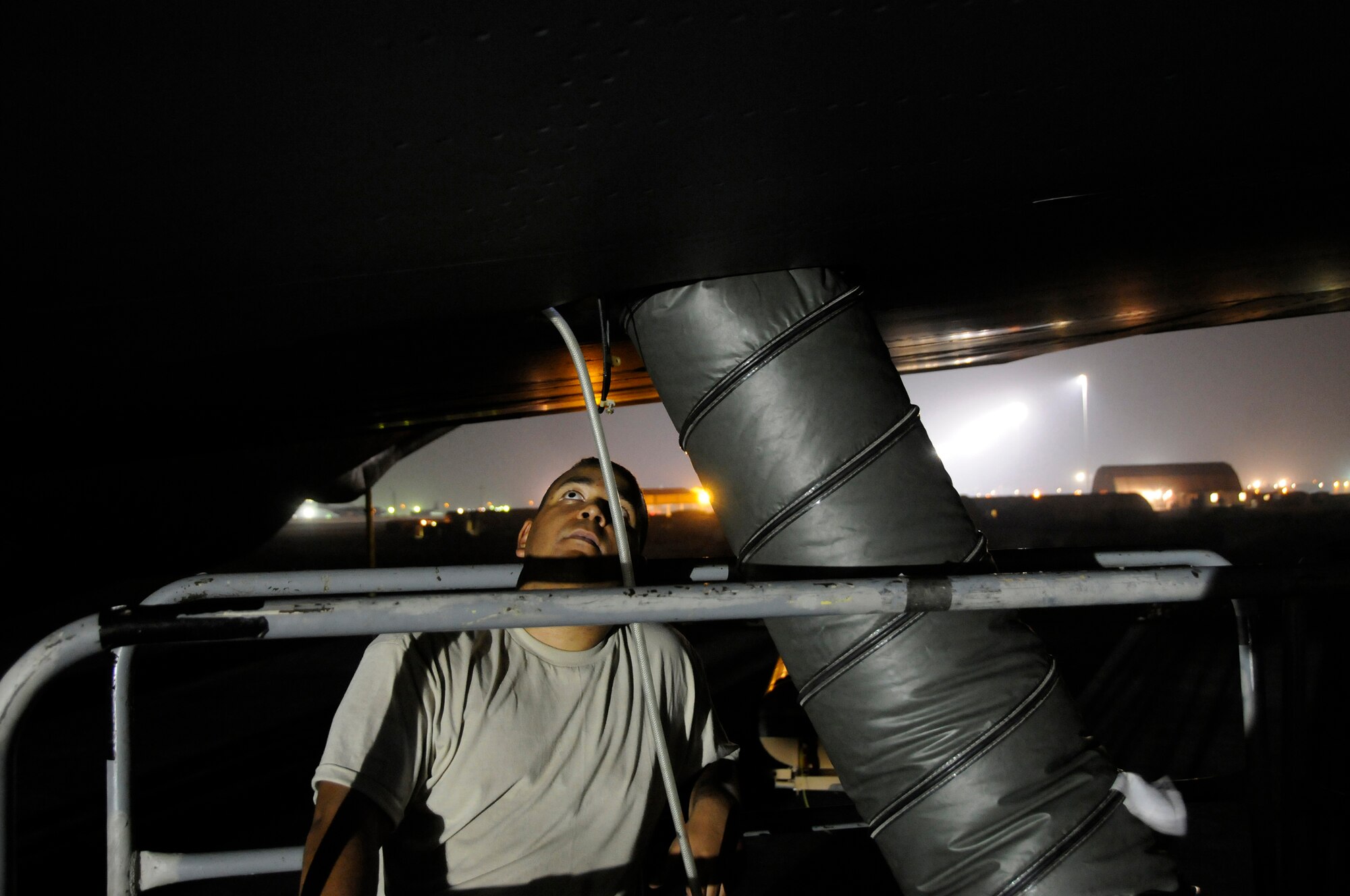 Staff Sergeant Eric Holmes, 379th Expeditionary Aircraft Maintenance Squadron, talks his partner, up inside the fuel tank, through a fuel tank probe change in a KC-135 Stratotanker, October 16, 2008.  A three-man crew is replacing a compensator probe on the Stratotanker's main fuel tank at an undisclosed air base in Southwest Asia.  The KC-135 provides the core aerial refueling capability for the United States Air Force and provides aerial refueling support to Navy, Marine Corps and allied nation aircraft.  Sergeant Holmes, a native of Tampa Bay, Fla., is deployed from McConnell Air Force Base, Kan., in support of Operations Iraqi and Enduring Freedom and Joint Task Force-Horn of Africa.  (U.S. Air Force photo by Tech. Sgt. Michael Boquette/Released)