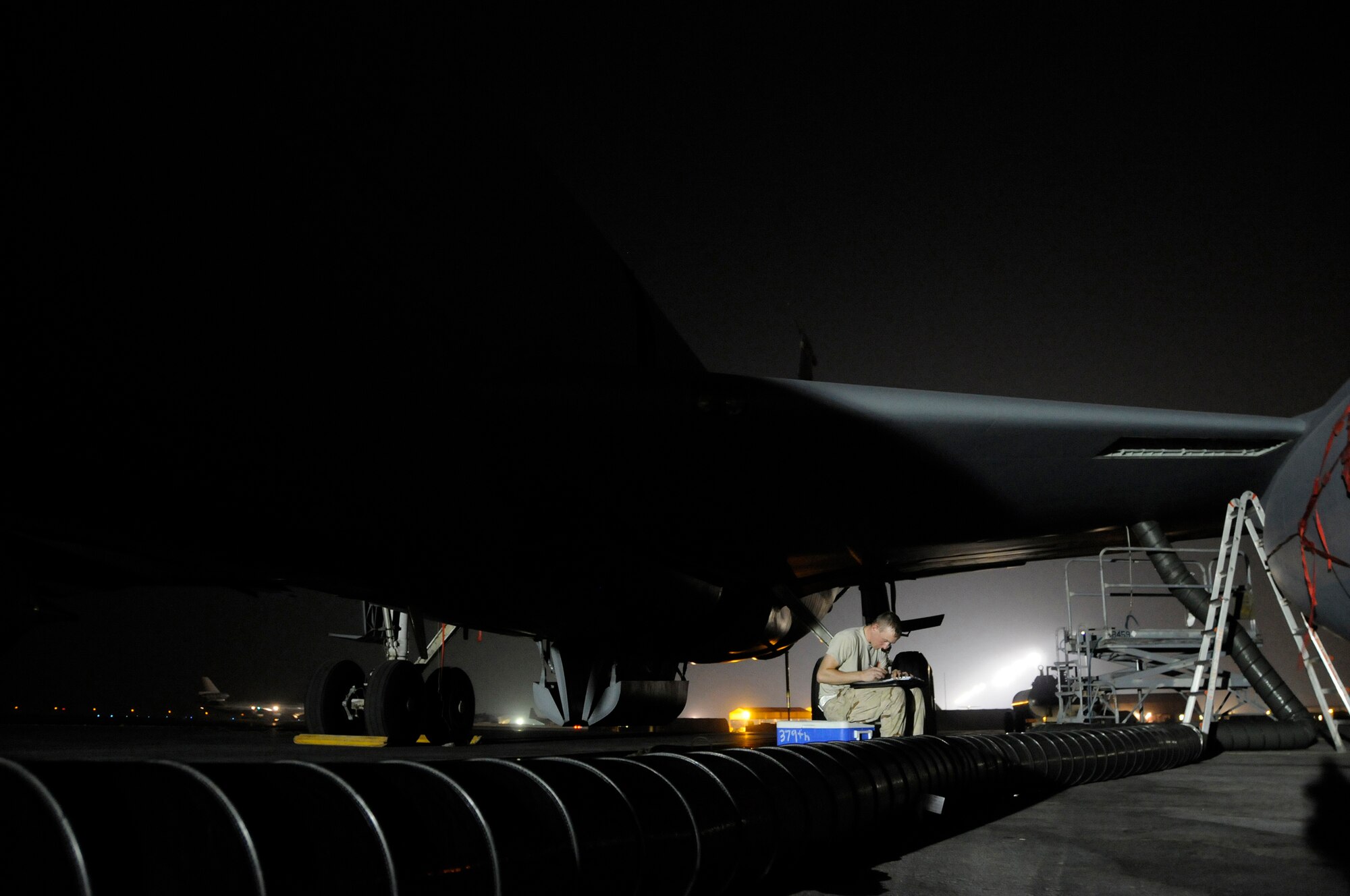 Airman 1st Class Stephen Murphy, 379th Expeditionary Aircraft Maintenance Squadron, completes a detailed maintenance log for a KC-135 Stratotanker, October 16, 2008, at an undisclosed air base in Southwest Asia.  The forms detail each part taken from or added to the aircraft and all other maintenance procedures performed on the Stratotanker.  A three-man crew is replacing a compensator probe on the Stratotanker's main fuel tank at an undisclosed air base in Southwest Asia.  The KC-135 provides the core aerial refueling capability for the United States Air Force and provides aerial refueling support to Navy, Marine Corps and allied nation aircraft.  Airman Murphy, a native of Cresco, Iowa, is deployed from Grand Forks Air Force Base, N.D., in support of Operations Iraqi and Enduring Freedom and Joint Task Force-Horn of Africa.  (U.S. Air Force photo by Tech. Sgt. Michael Boquette/Released)