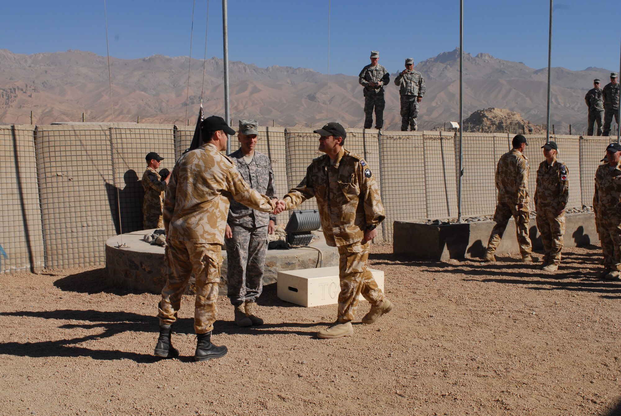 Outgoing New Zealand/Bamyan Provincial Reconstruction Team commander Col. Daryl Tracy shakes hands with incoming NZ/Bamyan PRT commander Col. Rich Hall during the PRT change of authority. Combined Joint Task Force 101's Task Force Warrior Commander Col. Scott Spellmon looks on. TF Warrior serves as the higher headquarters for the Bamyan/New Zealand PRT. New Zealand Defence Force TG Crib 12 has completed six months in Bamyan and has been succeeded by TG Crib 13.
