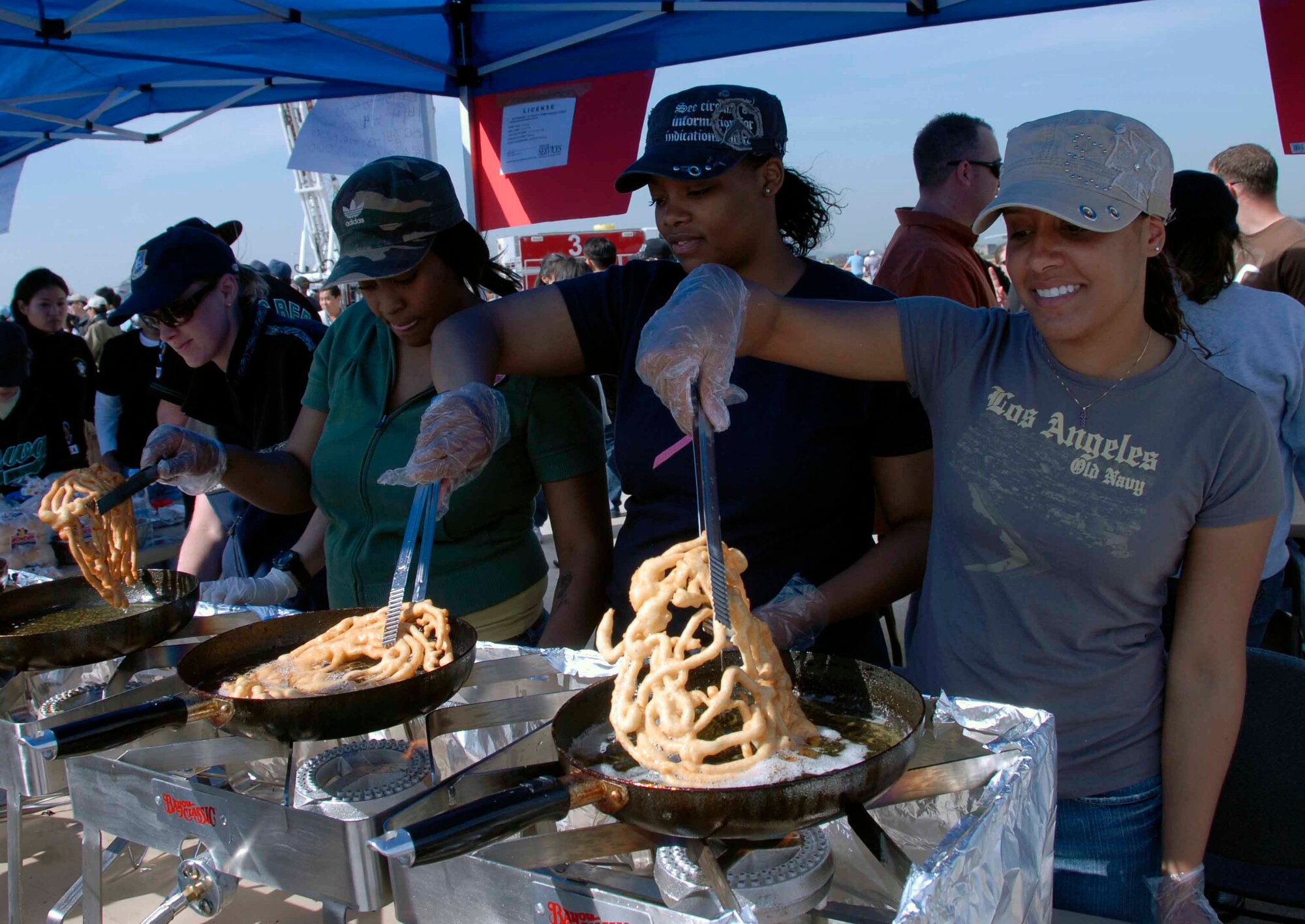 OSAN AIR BASE, Republic of Korea -- Members of the 51st Security Forces Squadron fry up funnel cakes during Air Power Day 2008. A variety of food, activities and information booths added to the success of the two-day event. (U.S. Air Force photo/Staff Sgt. Candy Knight)