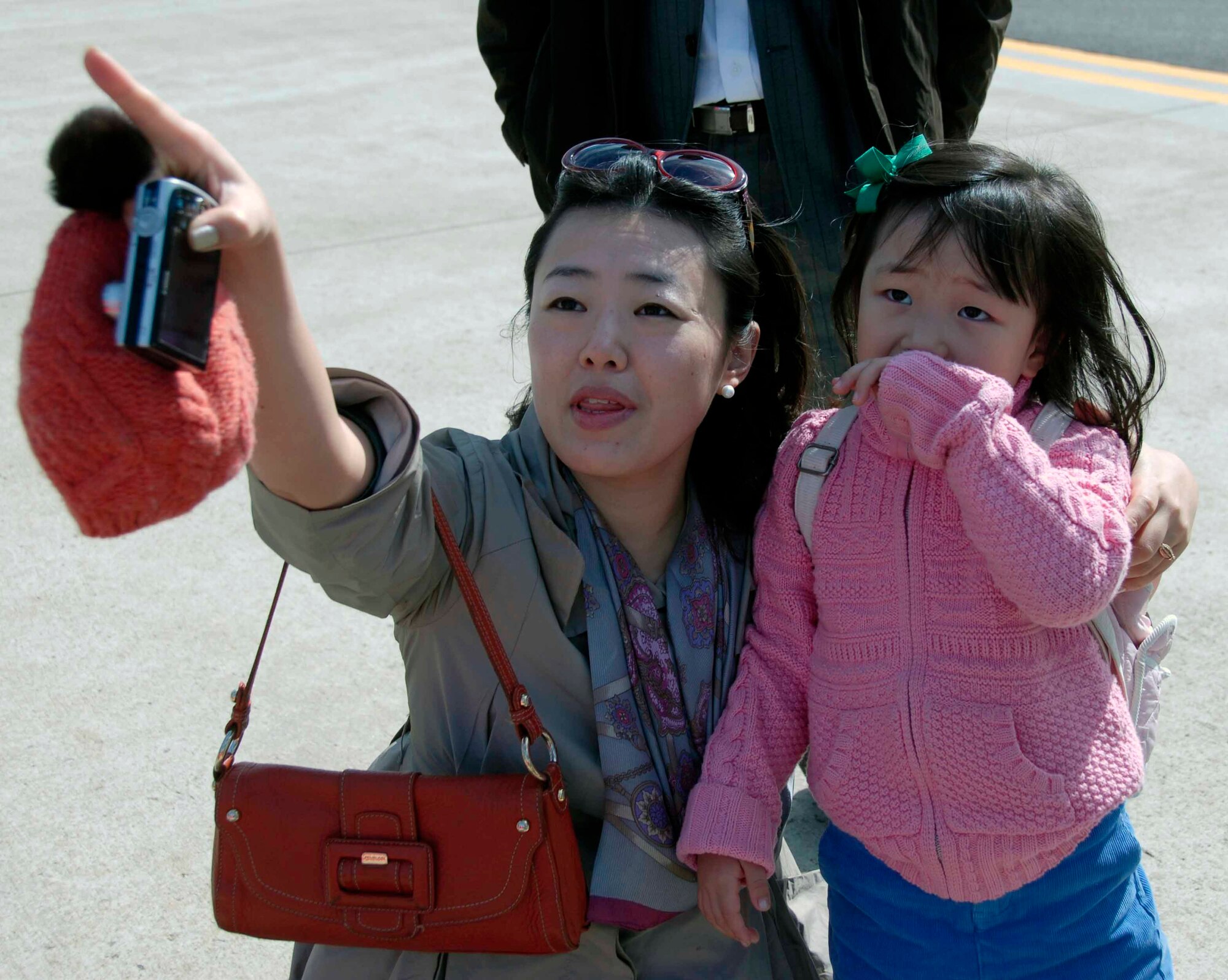 OSAN AIR BASE, Republic of Korea -- Spectators watch an aerial demonstration during Air Power Day 2008. The event featured aerial demonstrations of the A-10 “Thunderbolt II,” F-16 “Fighting Falcon,” U-2 “Dragon Lady,” the ROKAF F-4 “Phantom” and TA-50 “Golden Eagle" aircraft. (U.S. Air Force photo/Staff Sgt. Candy Knight)