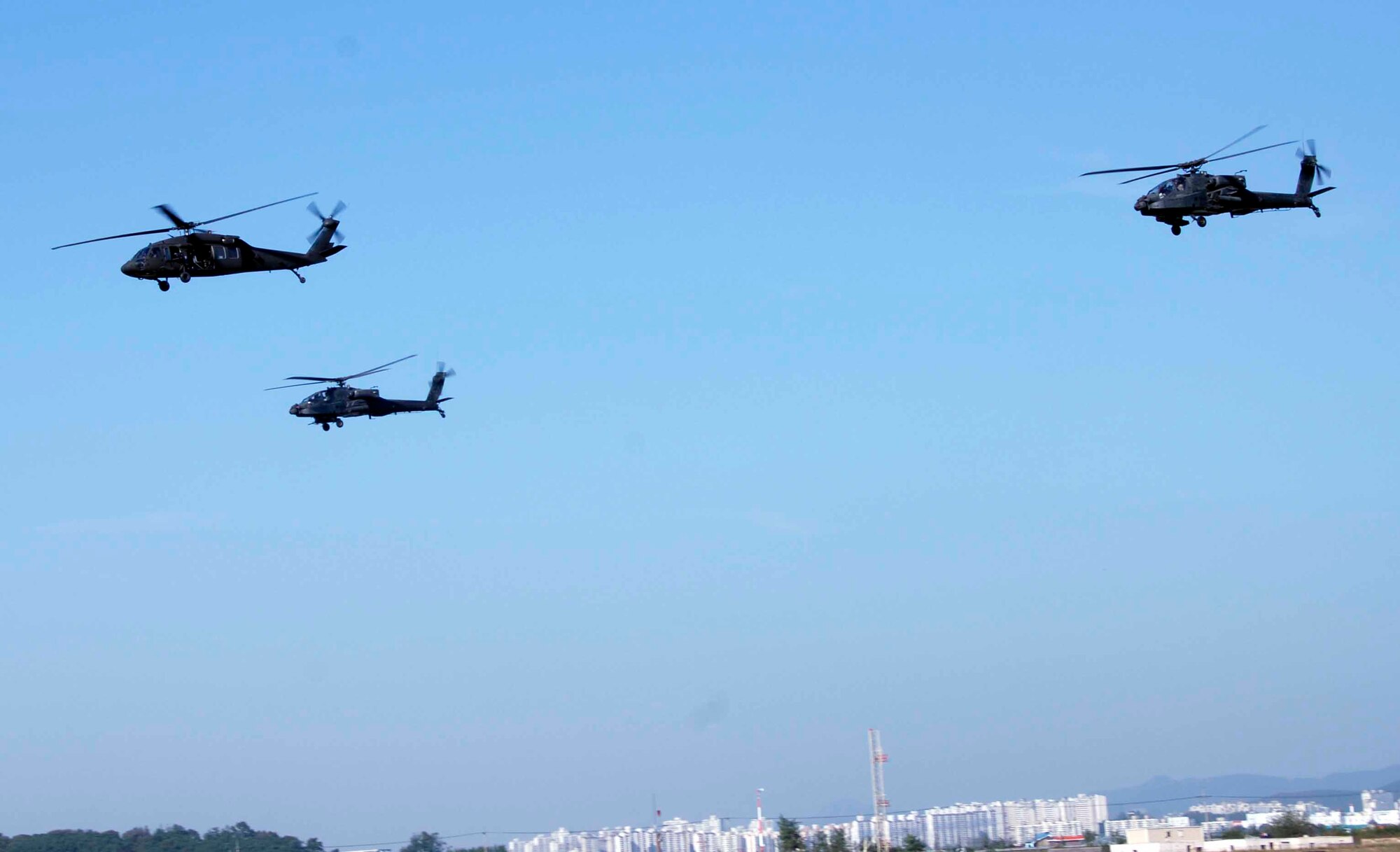 OSAN AIR BASE, Republic of Korea -- Army Apache and Blackhawk helicopters perform an aerial demonstration during Air Power Day 2008. The 51st Fighter Wing hosted its annual Air Power Day Oct. 11 and 12. This year’s event commemorated the 60th anniversaries of both the 51st FW and the Republic of Korea Armed Forces. (U.S. Air Force photo/Staff Sgt. Candy Knight)
