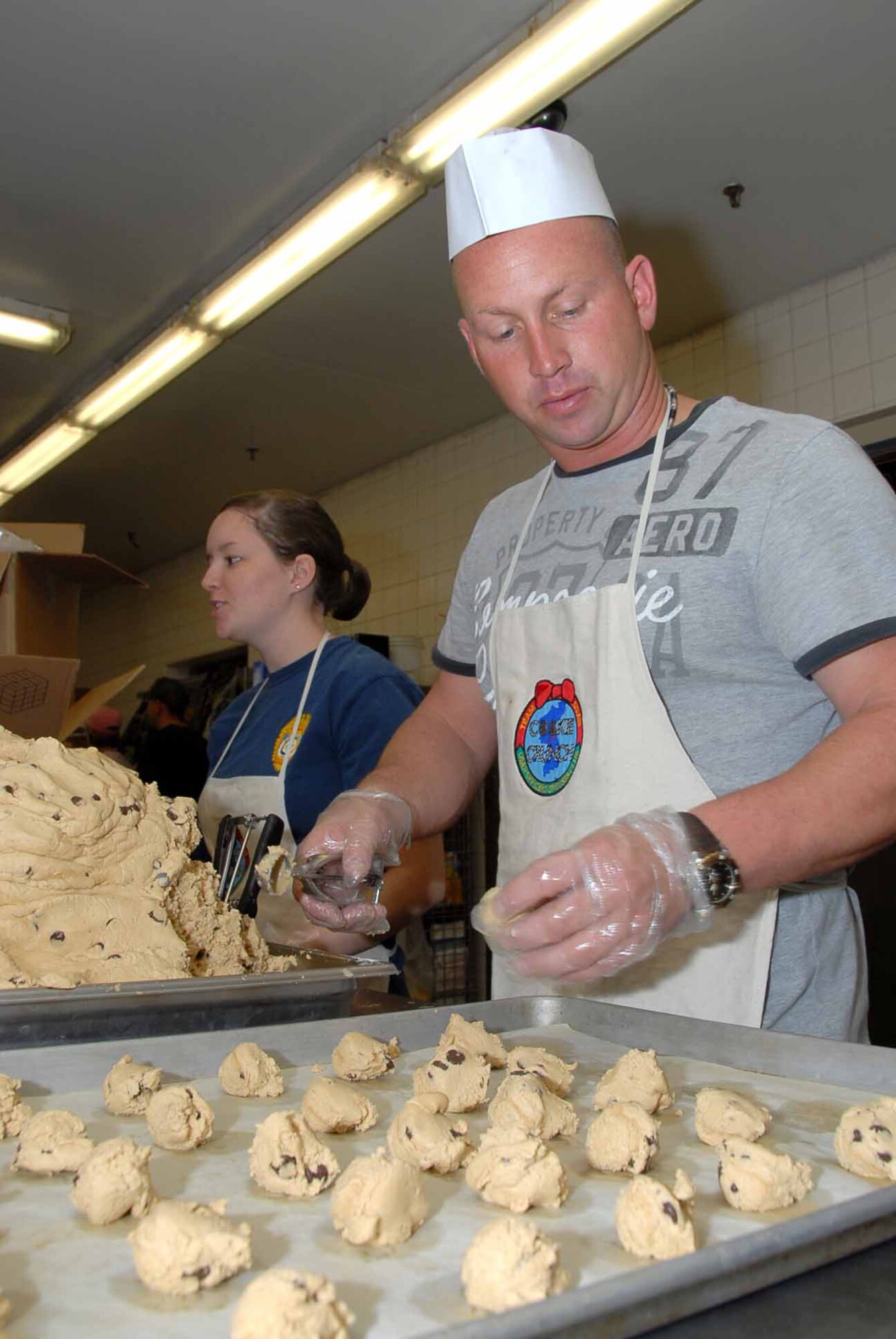 OSAN AIR BASE, Republic of Korea -- Staff Sgt. Scott Evol, Osan firefighter, prepares cookies for the annual Osan Cookie Crunch. During the holiday season, supporters bake and distribute more than 80,000 cookies to single and unaccompanied service members across the peninsula. (U.S. Air Force photo/Master Sgt. Marlin Zimmerman)
