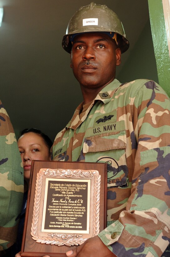 Chief Equipment Operator Jerry Greer, project chief for work at the Soccoro Sanchez Primary School, holds a plaque presented to the USS Kearsarge crew by the school staff for their hard work in Santo Dominigo, Dominican Republic, Oct. 14, 2008. 