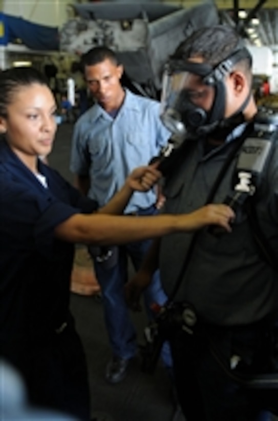 U.S. Navy Fireman Stacey Gallegos gives self-contained breathing apparatus training in the hangar bay of the amphibious assault ship USS Kearsarge (LHD 3) while underway in the Caribbean Sea during a subject matter expert exchange with Dominican sailors on Oct. 10, 2008.  The Kearsarge is supporting the Caribbean phase of Continuing Promise 2008, an equal-partnership mission involving the United States, Canada, the Netherlands, Brazil, France, Nicaragua, Colombia, Dominican Republic, Trinidad and Tobago and Guyana.  